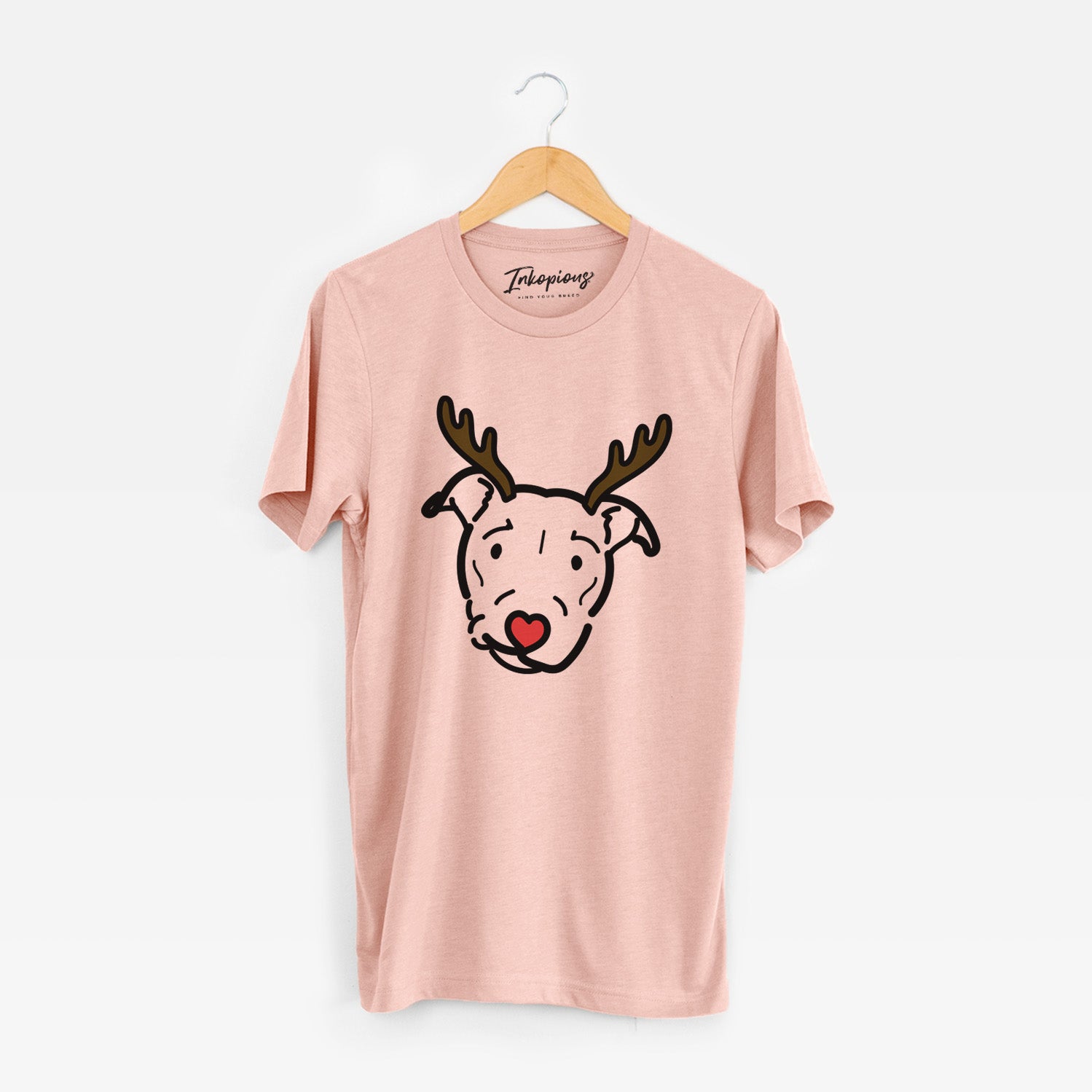 Minimalist line drawing of Ernie the Pitbull Mix with reindeer antlers and a red nose on a Peach Unisex crewneck