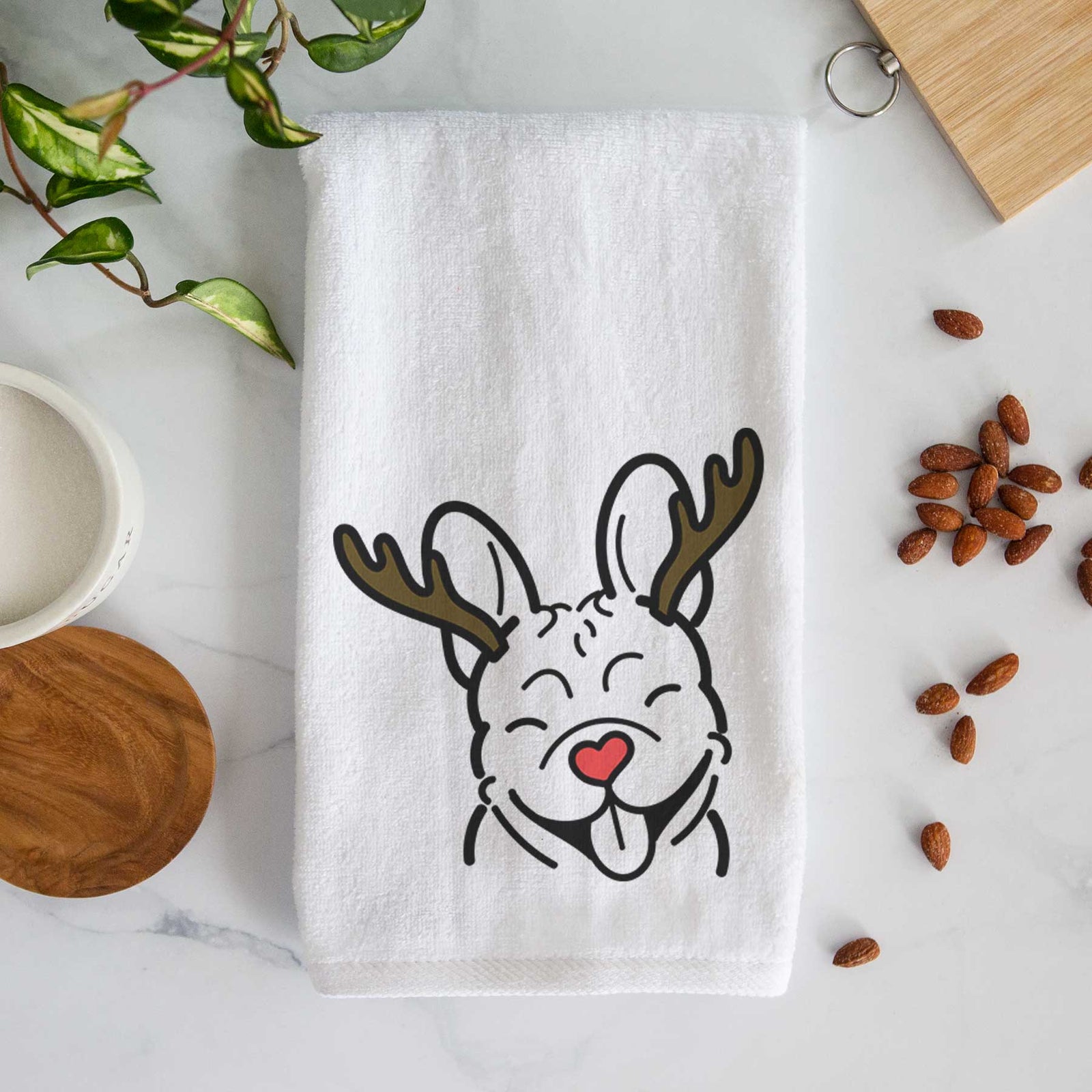 Minimalist line drawing of a French Bulldog with reindeer antlers and a red nose on a decorative hand towel