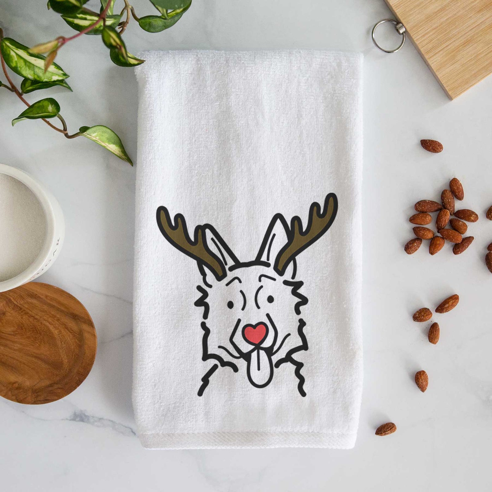 Minimalist line drawing of a German Shepherd with reindeer antlers and a red nose on a decorative hand towel