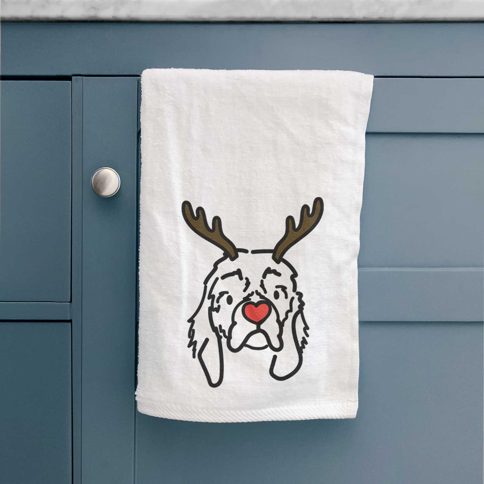 Minimalist line drawing of GiGi the Cocker Spaniel with reindeer antlers and a red nose on a decorative hand towel