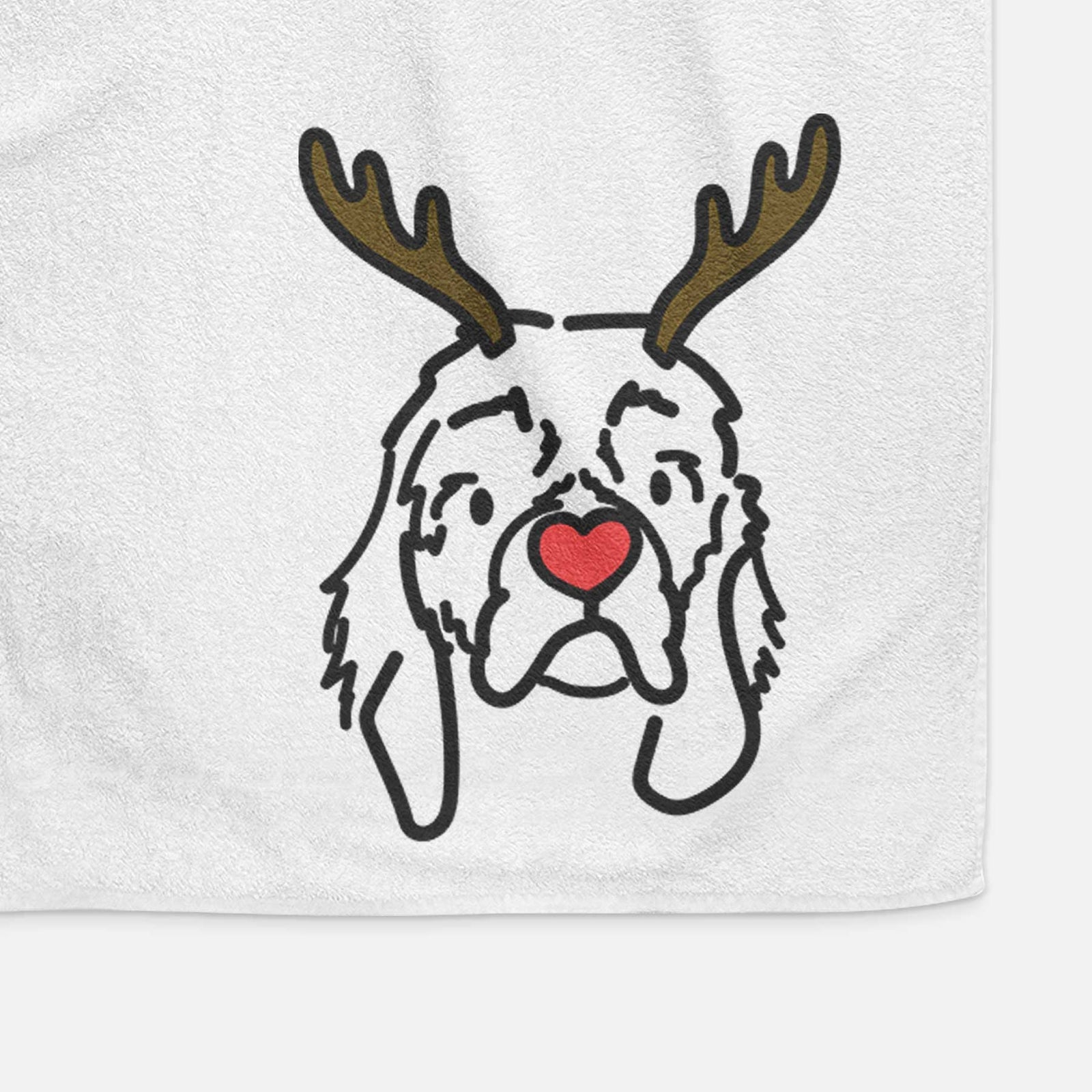 Minimalist line drawing of GiGi the Cocker Spaniel with reindeer antlers and a red nose on a decorative hand towel
