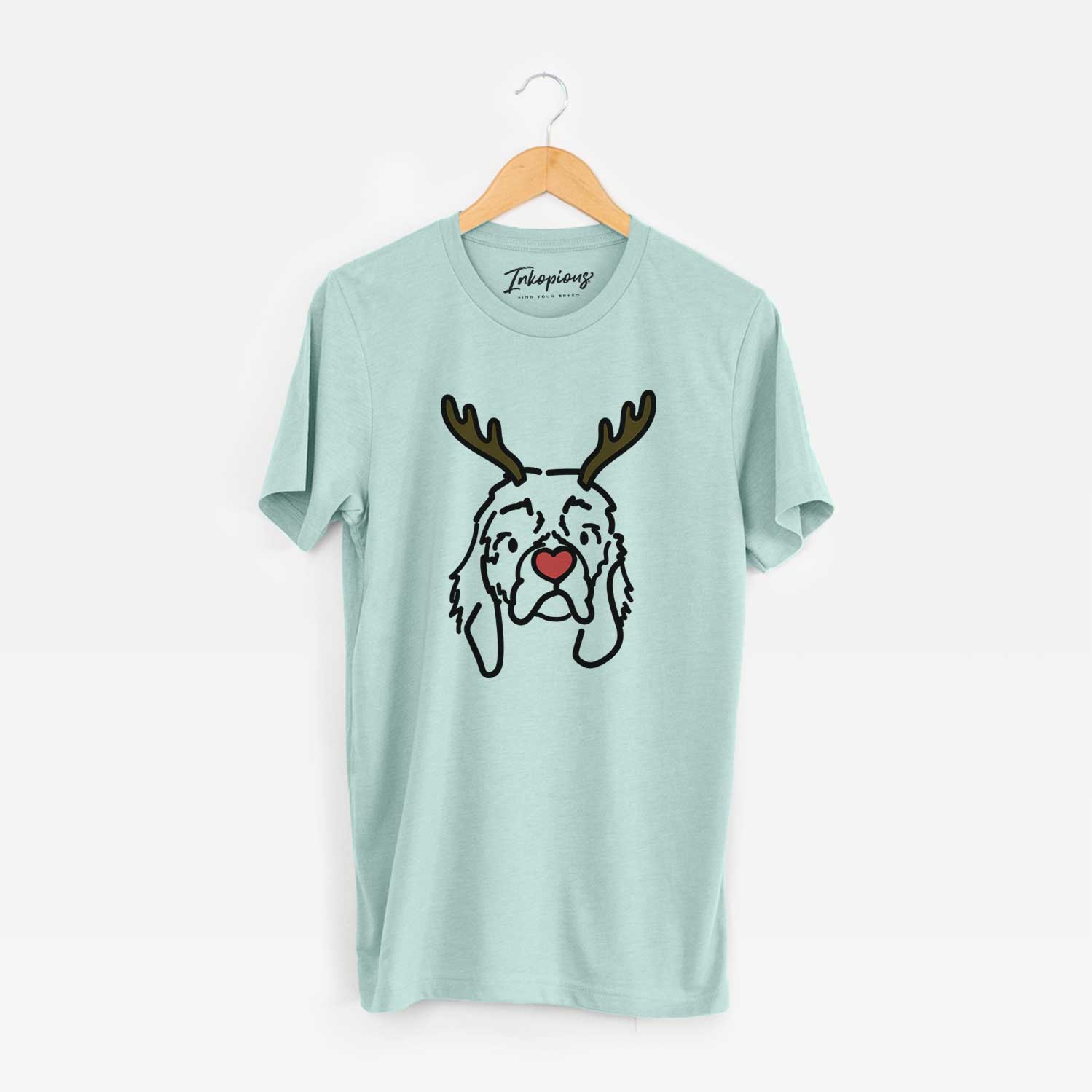 Minimalist line drawing of GiGi the Cocker Spaniel with reindeer antlers and a red nose on a Heather Sage Unisex crewneck