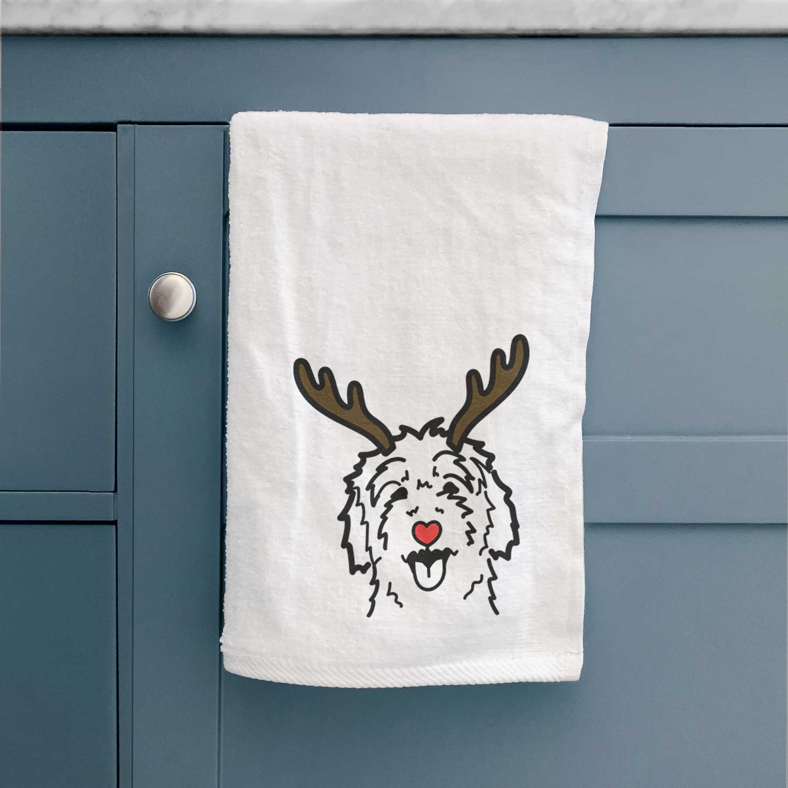 Minimalist line drawing of a Goldendoodle with reindeer antlers and a red nose on a decorative hand towel