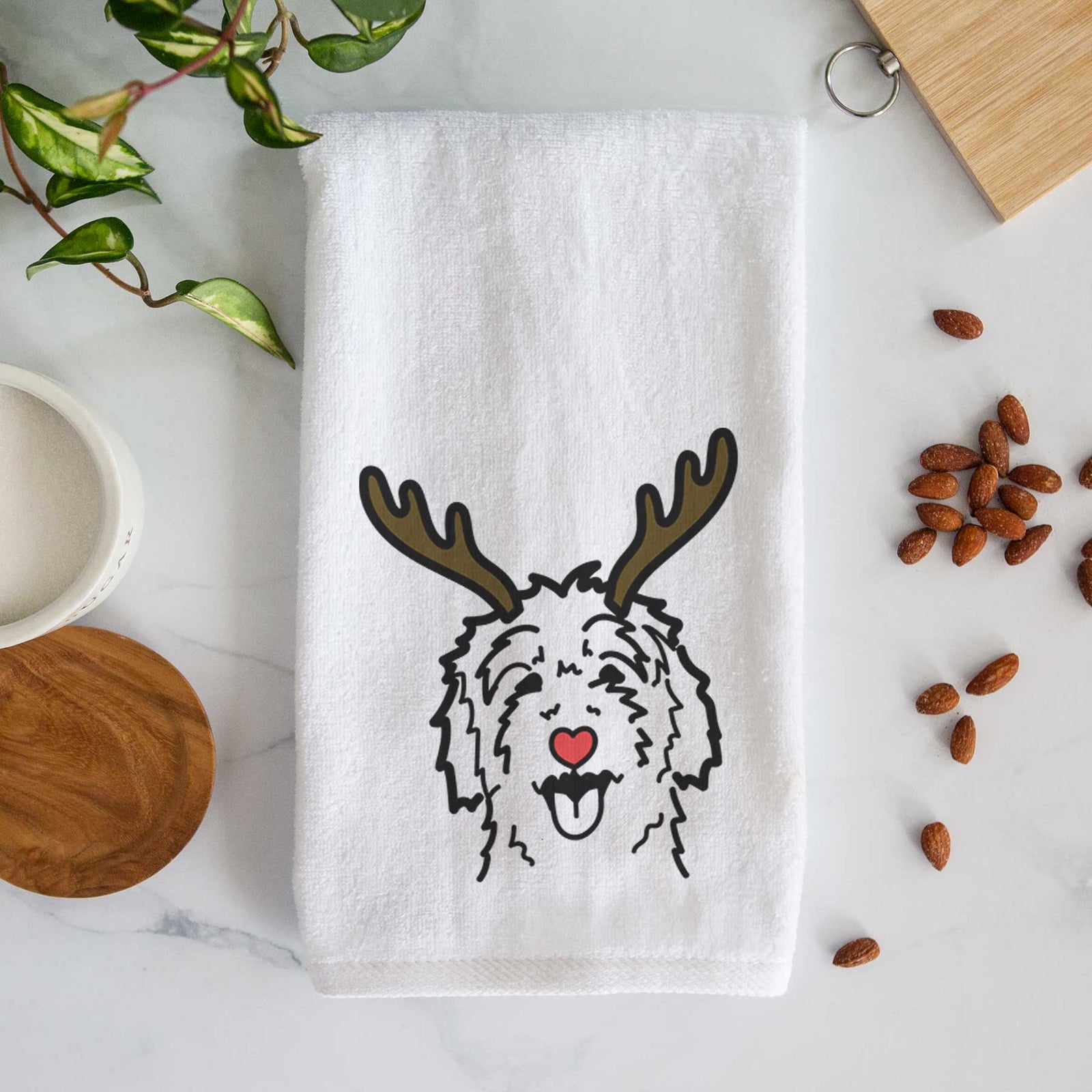 Minimalist line drawing of a Goldendoodle with reindeer antlers and a red nose on a decorative hand towel