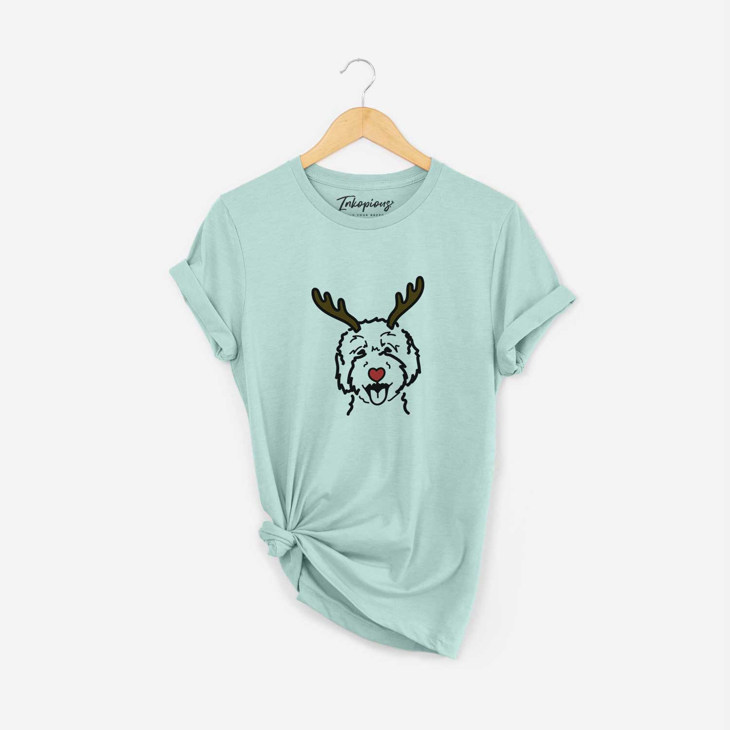 Minimalist line drawing of a Goldendoodle 2 with reindeer antlers and a red nose on a Heather Sage Unisex crewneck