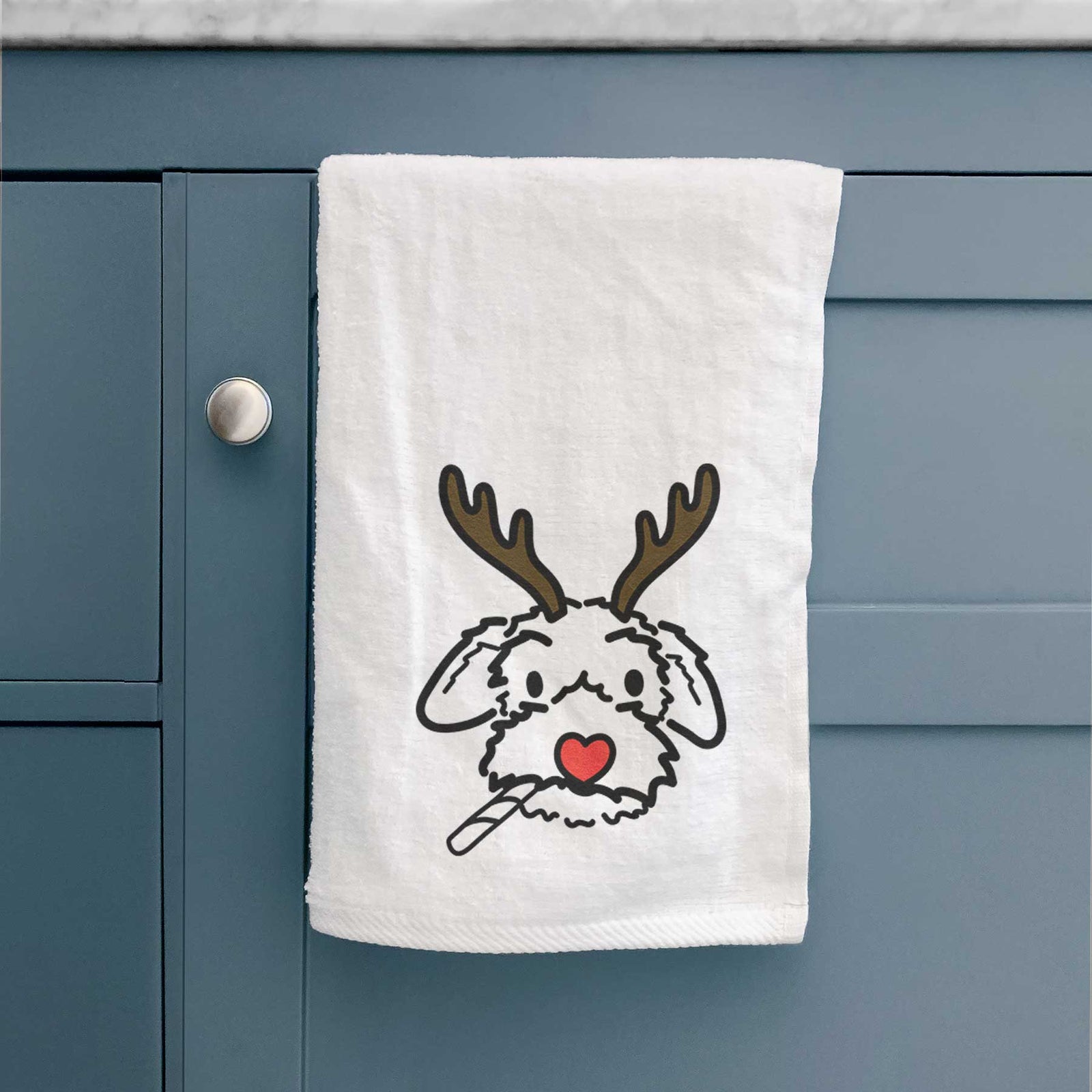 Minimalist line drawing of Gomer the Poodle Mix with reindeer antlers and a red nose on a decorative hand towel