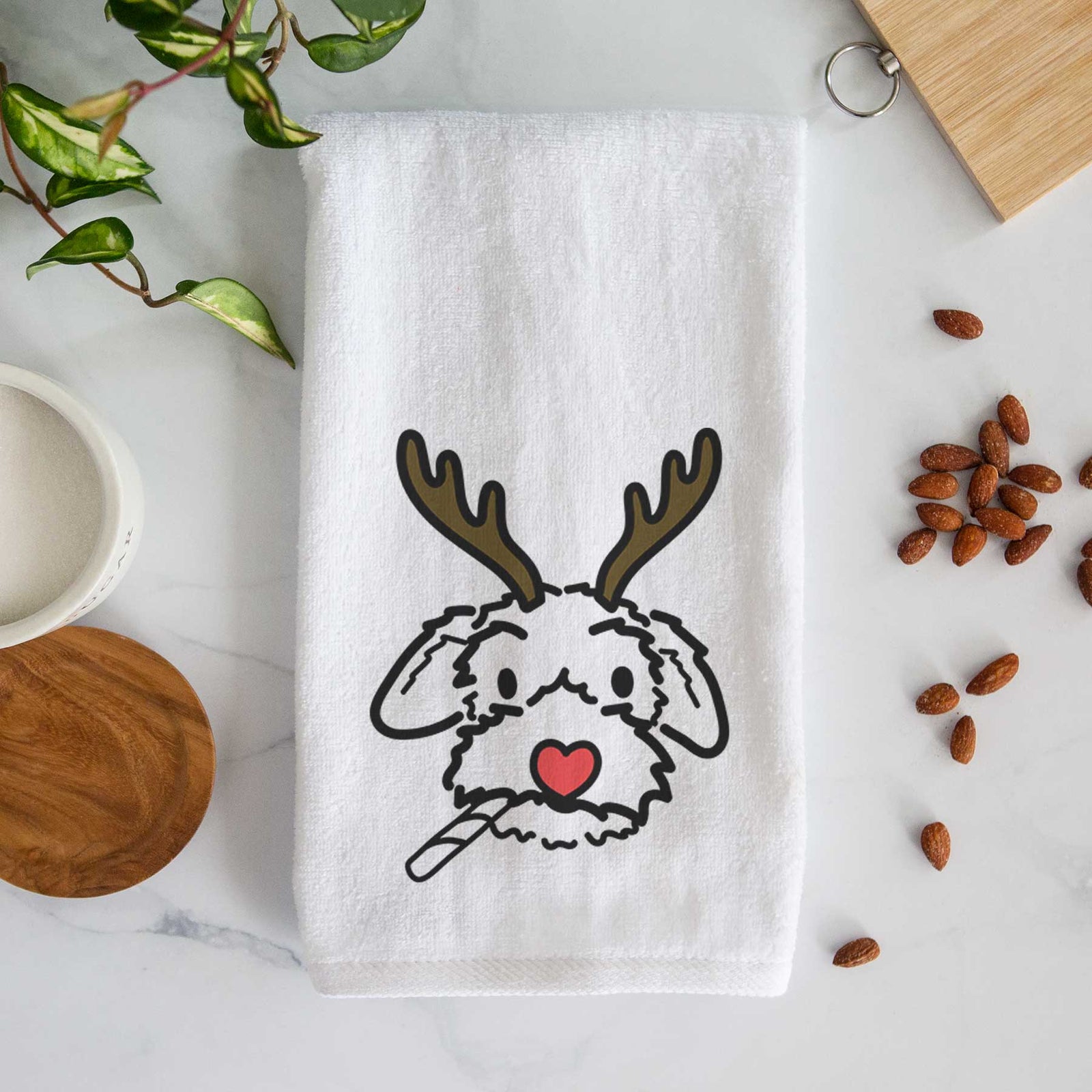 Minimalist line drawing of Gomer the Poodle Mix with reindeer antlers and a red nose on a decorative hand towel