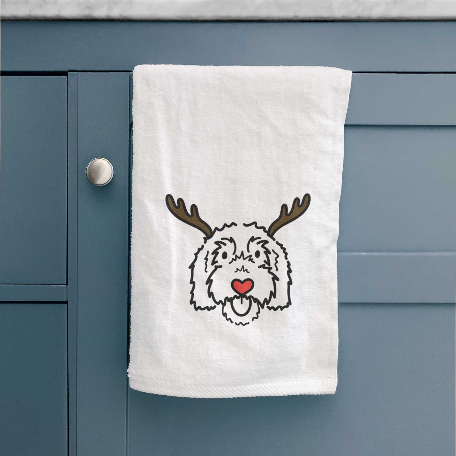 Minimalist line drawing of Gus the Goldendoodle with reindeer antlers and a red nose on a decorative hand towel