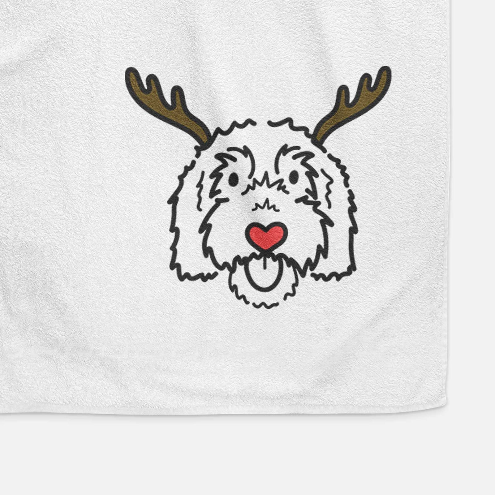 Minimalist line drawing of Gus the Goldendoodle with reindeer antlers and a red nose on a decorative hand towel