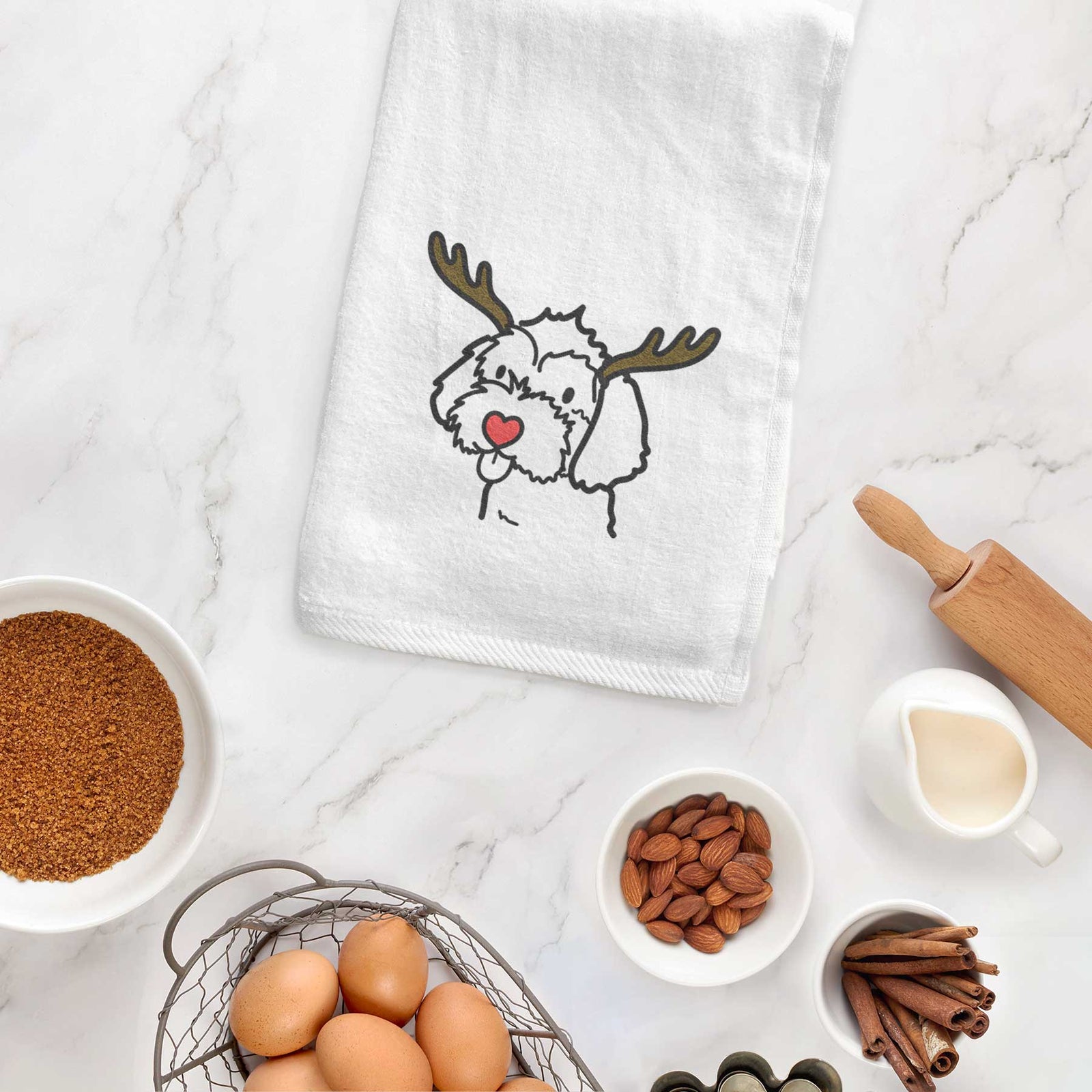 Minimalist line drawing of a Havapoo with reindeer antlers and a red nose on a decorative hand towel