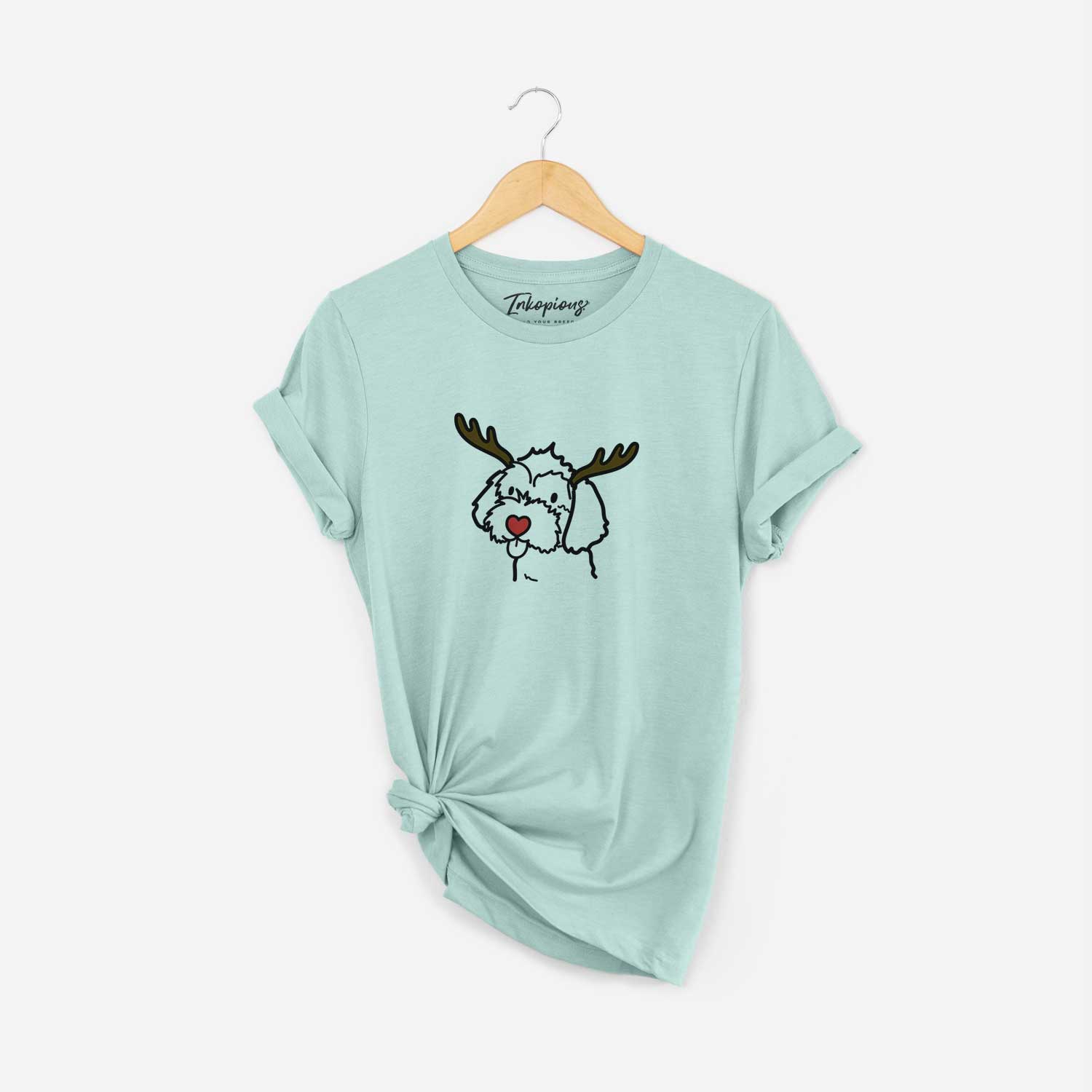 Minimalist line drawing of a Havapoo with reindeer antlers and a red nose on a Heather Sage Unisex crewneck