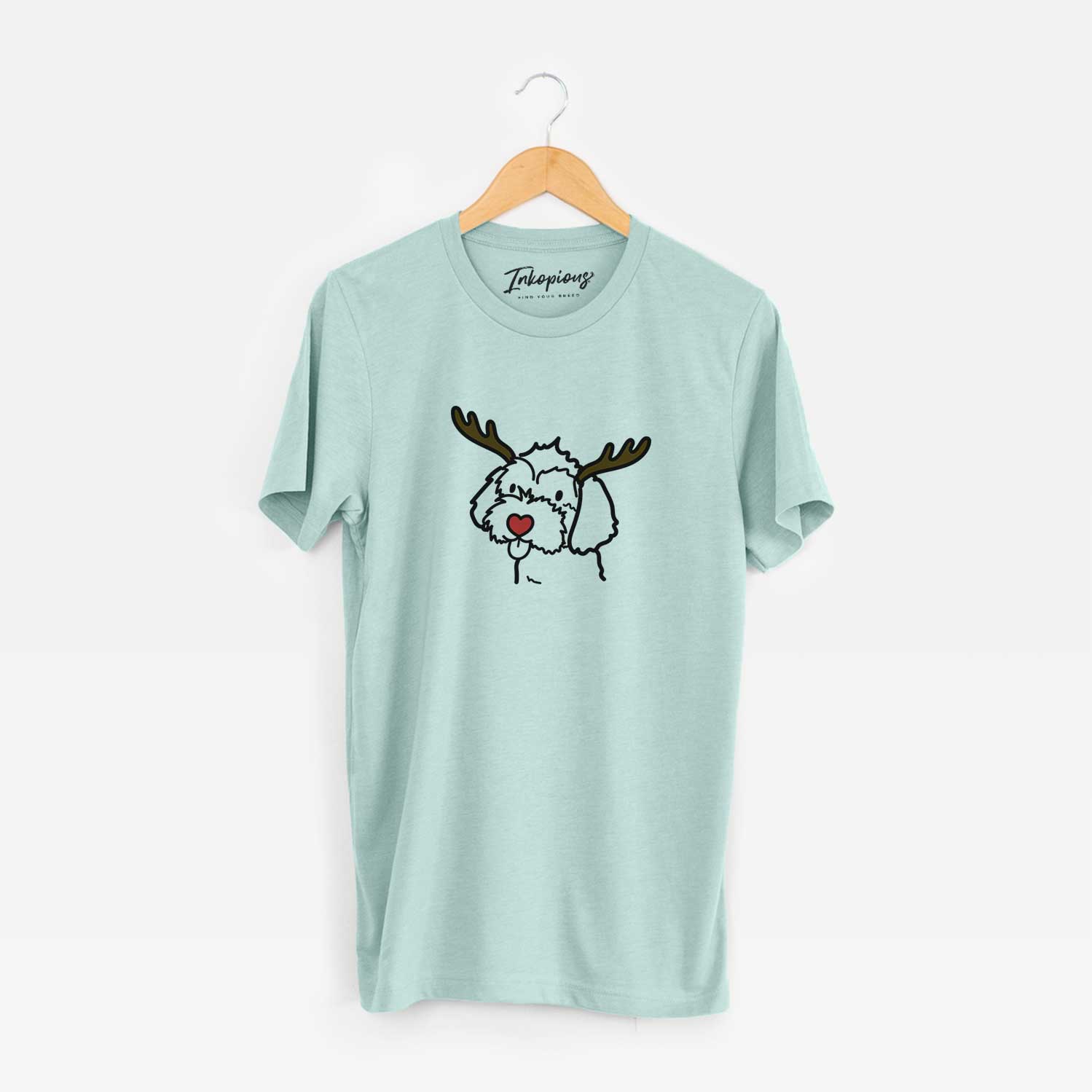 Minimalist line drawing of a Havapoo with reindeer antlers and a red nose on a Heather Sage Unisex crewneck