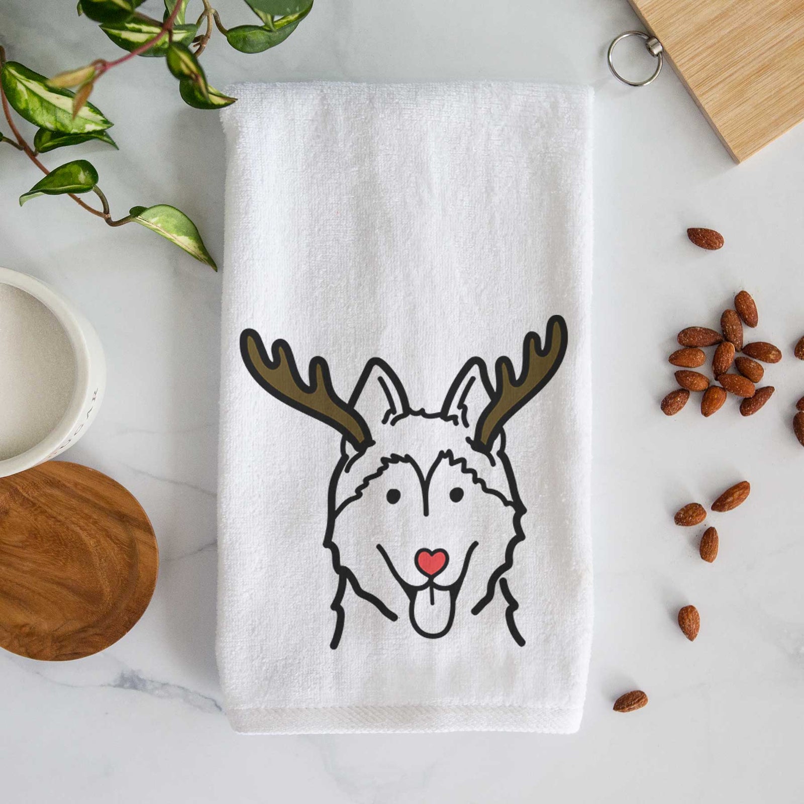 Minimalist line drawing of a Siberian Husky with reindeer antlers and a red nose on a decorative hand towel