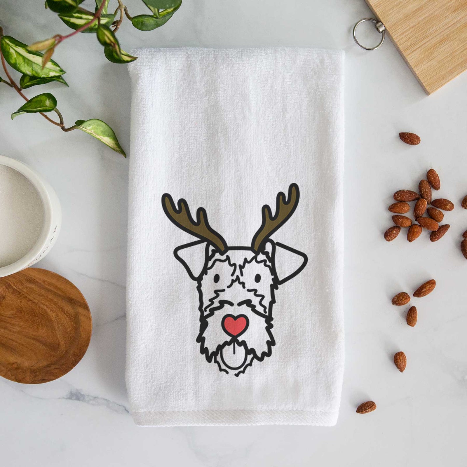 Minimalist line drawing of an Irish Terrier with reindeer antlers and a red nose on a decorative hand towel
