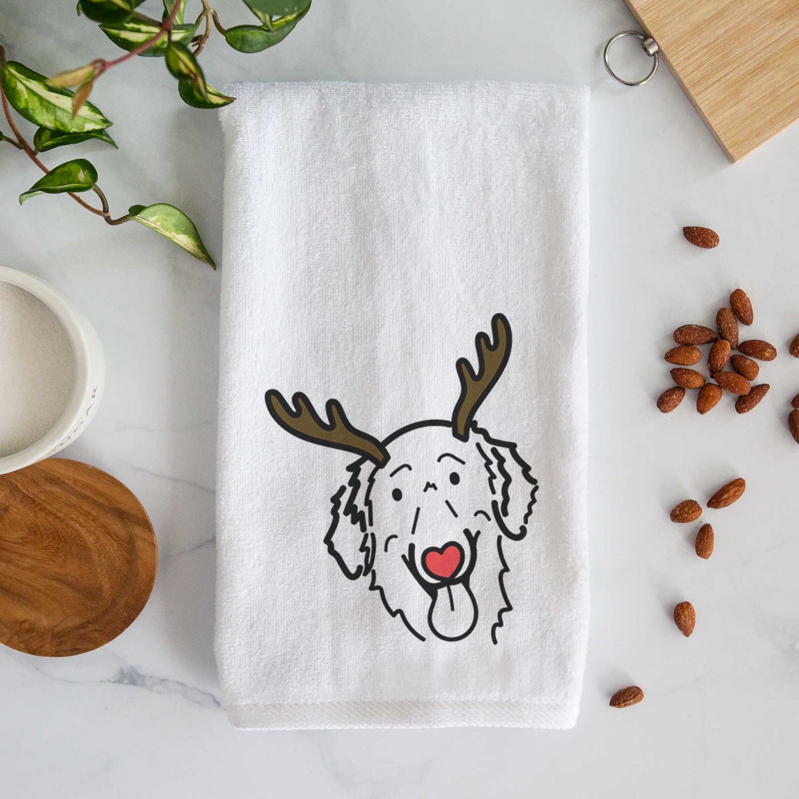 Minimalist line drawing of Jack the Flat-Coated Retriever with reindeer antlers and a red nose on a decorative hand towel