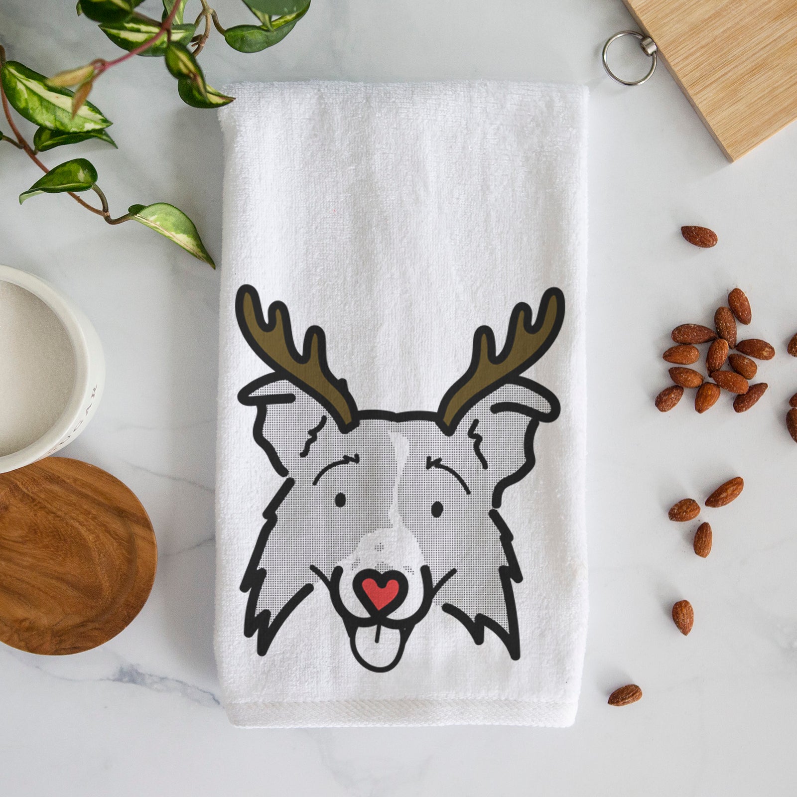 Minimalist line drawing of Jam the Border Collie 2.0 with reindeer antlers and a red nose on a decorative hand towel