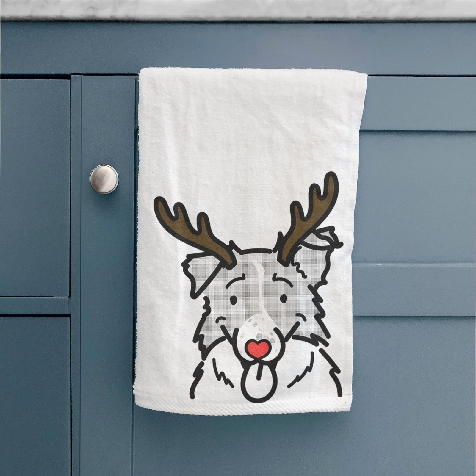 Minimalist line drawing of Jam the Border Collie with reindeer antlers and a red nose on a decorative hand towel