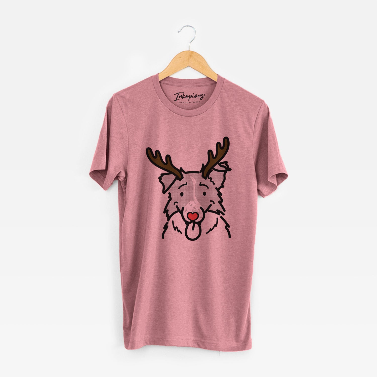 Minimalist line drawing of Jam the Border Collie with reindeer antlers and a red nose on a Mauve Unisex crewneck