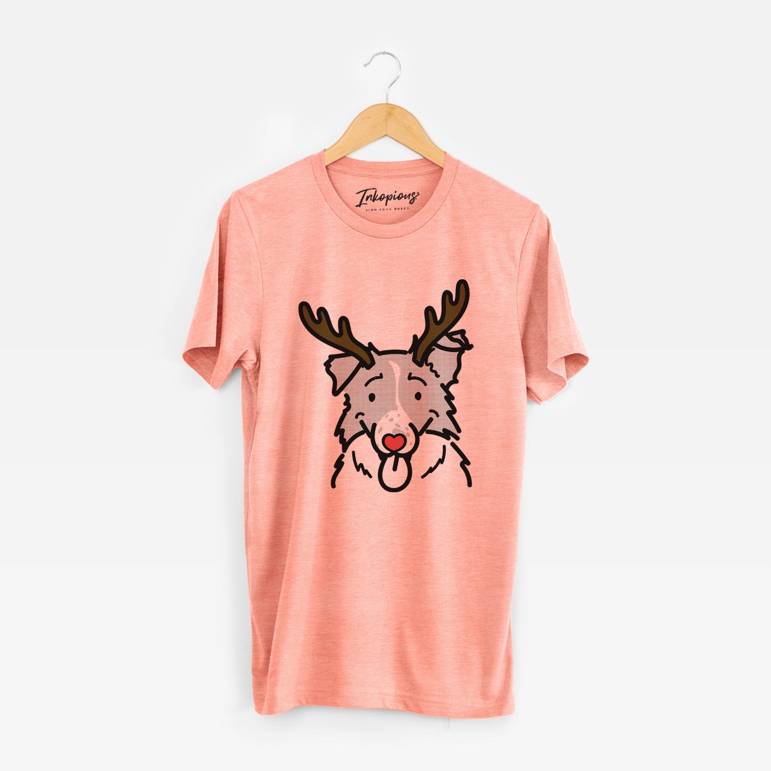 Minimalist line drawing of Jam the Border Collie with reindeer antlers and a red nose on a Sunset Unisex crewneck
