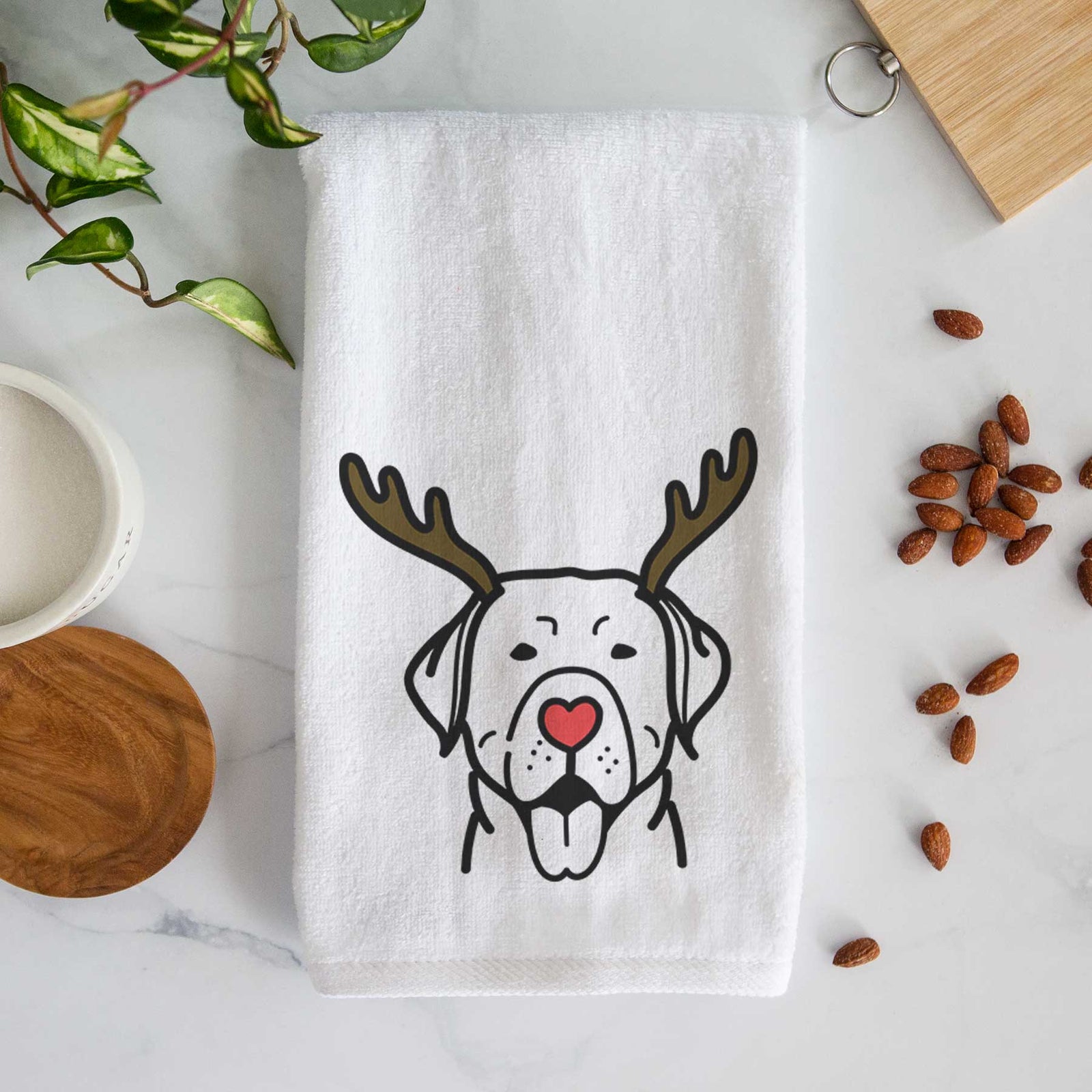 Minimalist line drawing of a Labrador Retriever with reindeer antlers and a red nose on a decorative hand towel