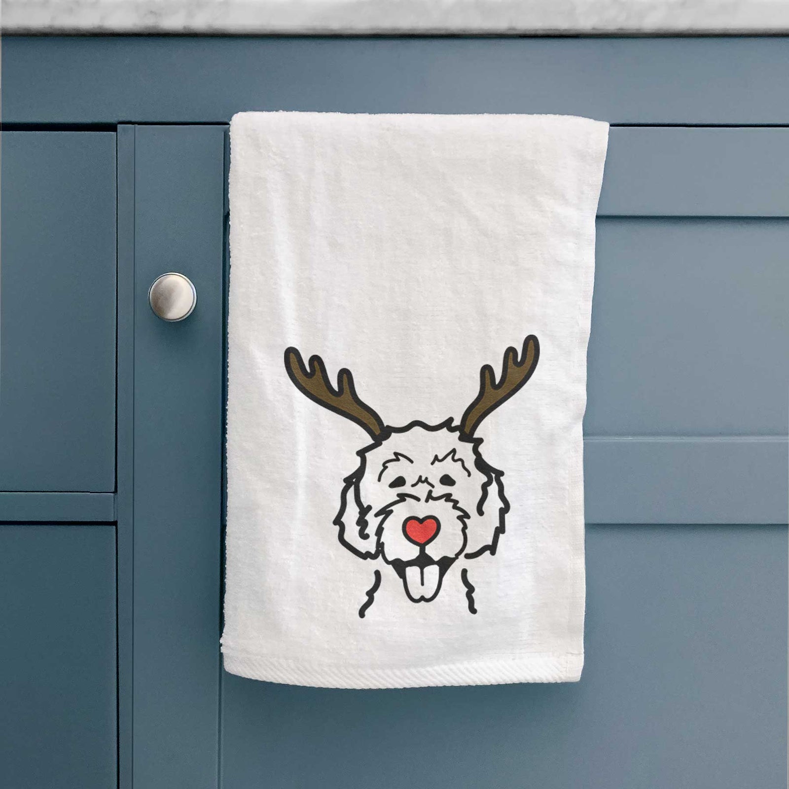 Minimalist line drawing of a Labradoodle with reindeer antlers and a red nose on a decorative hand towel