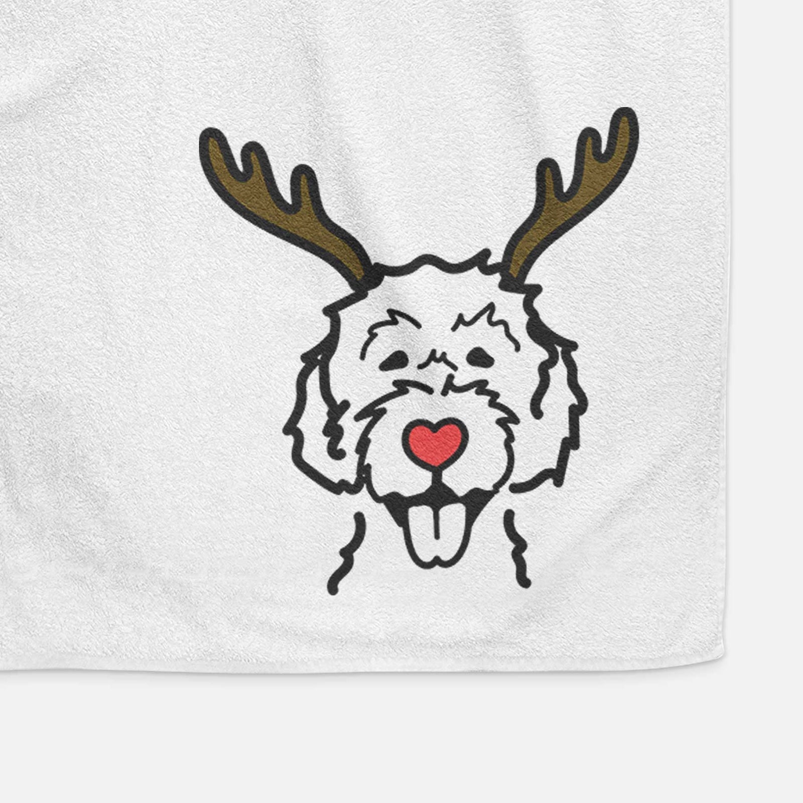 Minimalist line drawing of a Labradoodle with reindeer antlers and a red nose on a decorative hand towel