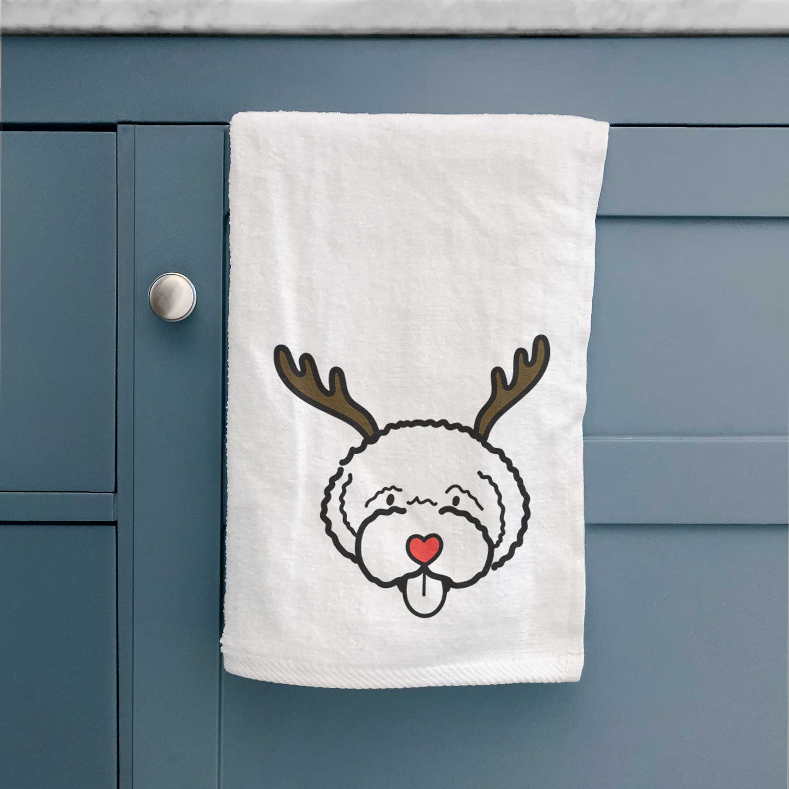 Minimalist line drawing of a Lagotta Romagnolo with reindeer antlers and a red nose on a decorative hand towel