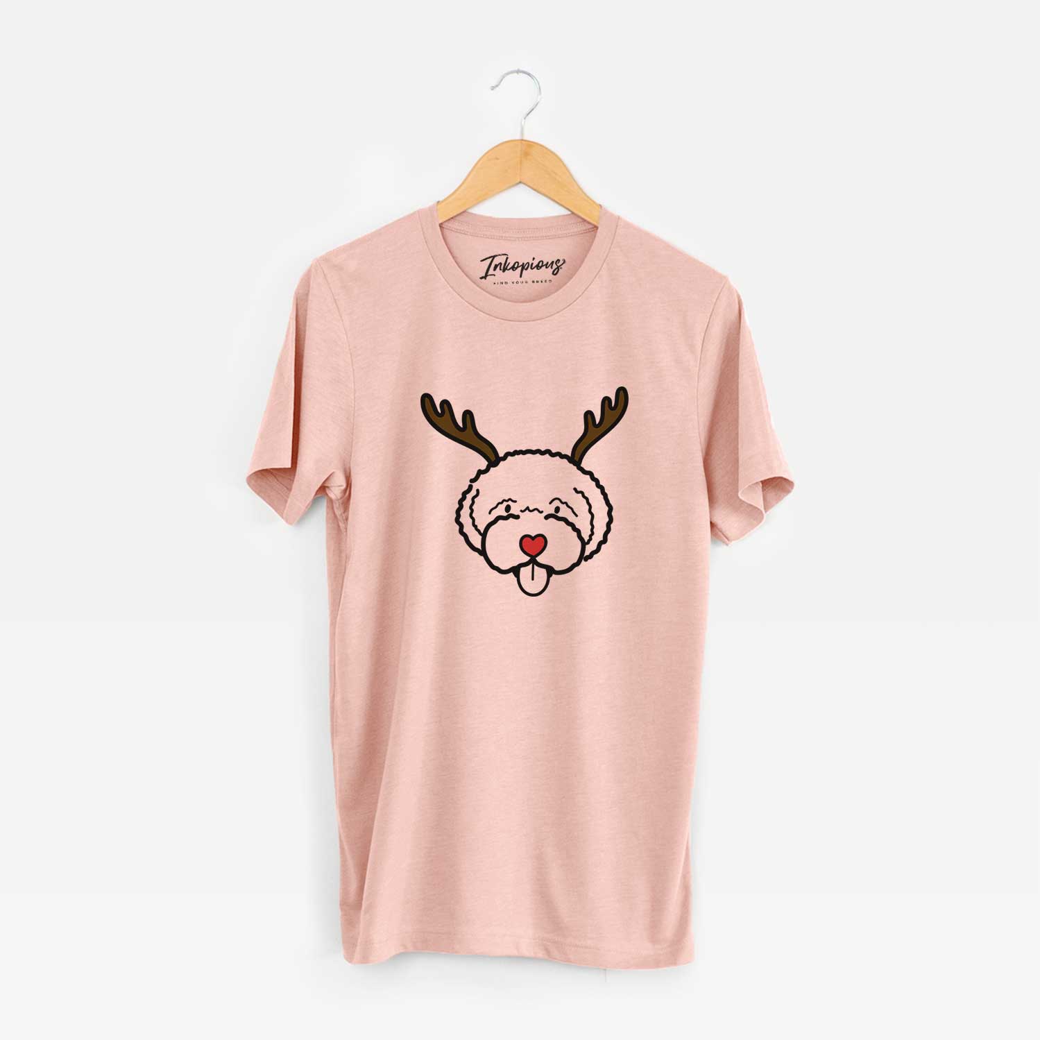 Minimalist line drawing of a Lagotta Romagnolo with reindeer antlers and a red nose on a Peach Unisex crewneck