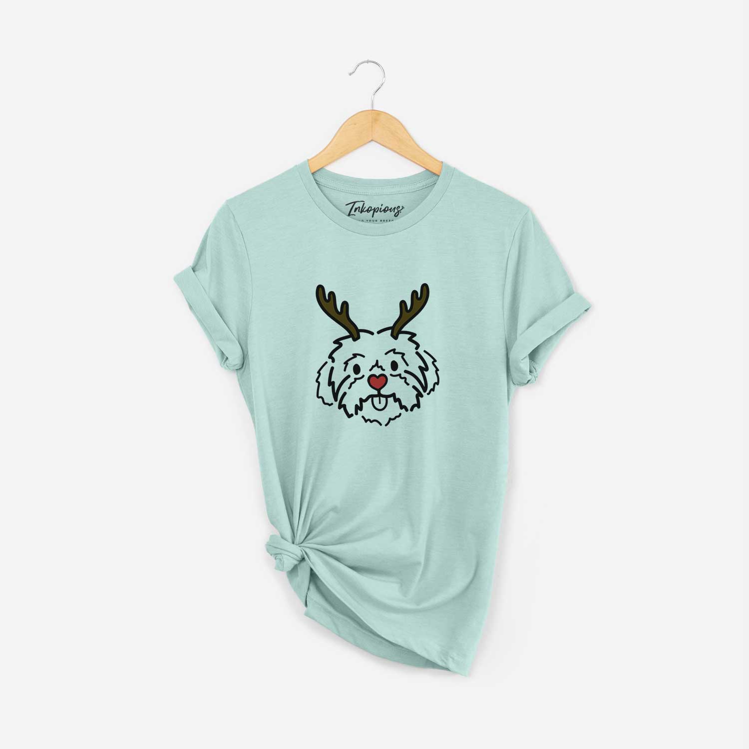 Minimalist line drawing of Leo the Shih Tzu with reindeer antlers and a red nose on a Heather Sage Unisex crewneck