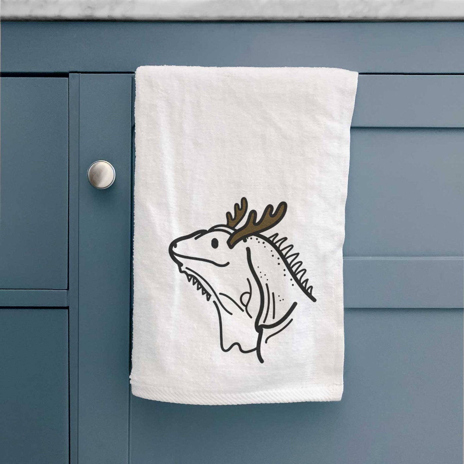 Minimalist line drawing of Louie the Iguana with reindeer antlers and a red nose on a decorative hand towel