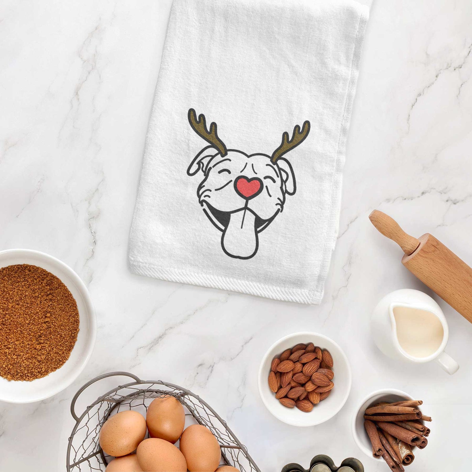 Minimalist line drawing of Louie the Pitbull with reindeer antlers and a red nose on a decorative hand towel