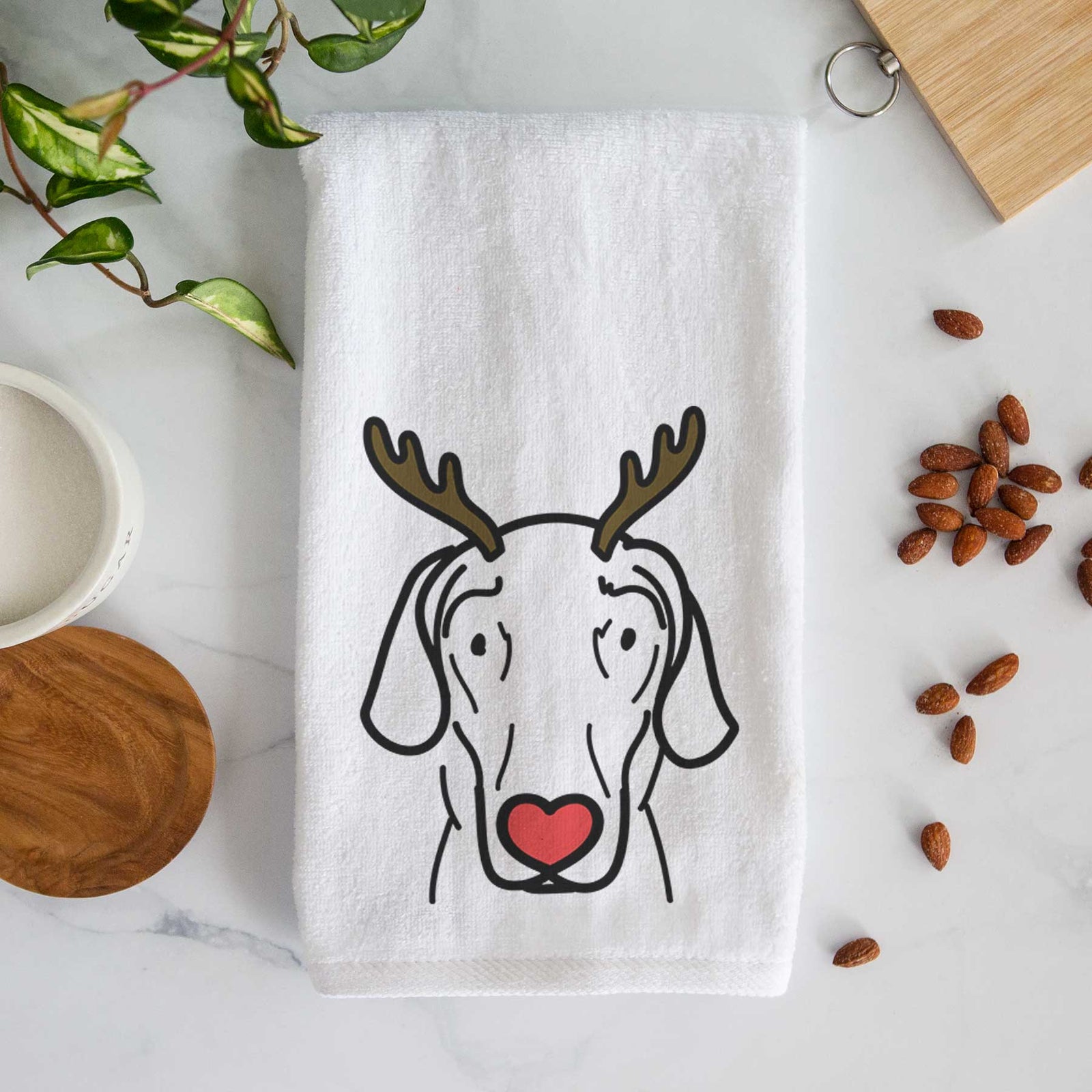 Minimalist line drawing of Lucy the Great Dane with reindeer antlers and a red nose on a decorative hand towel