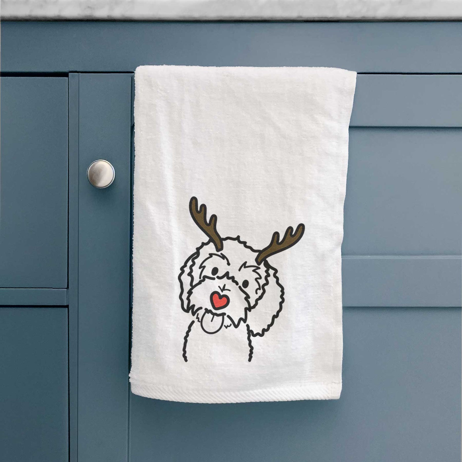 Minimalist line drawing of Mabel the Bernedoodle with reindeer antlers and a red nose on a decorative hand towel