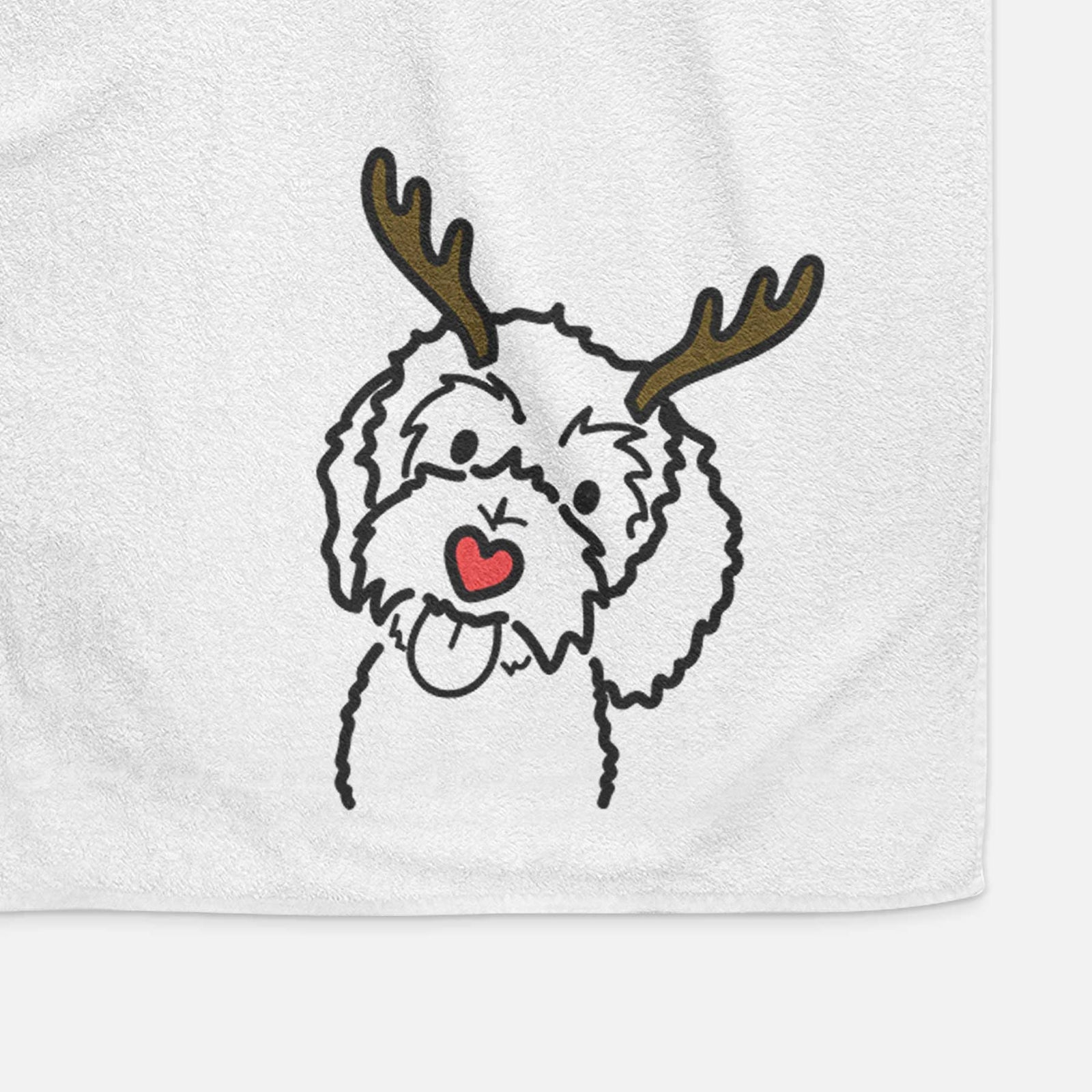 Minimalist line drawing of Mabel the Bernedoodle with reindeer antlers and a red nose on a decorative hand towel