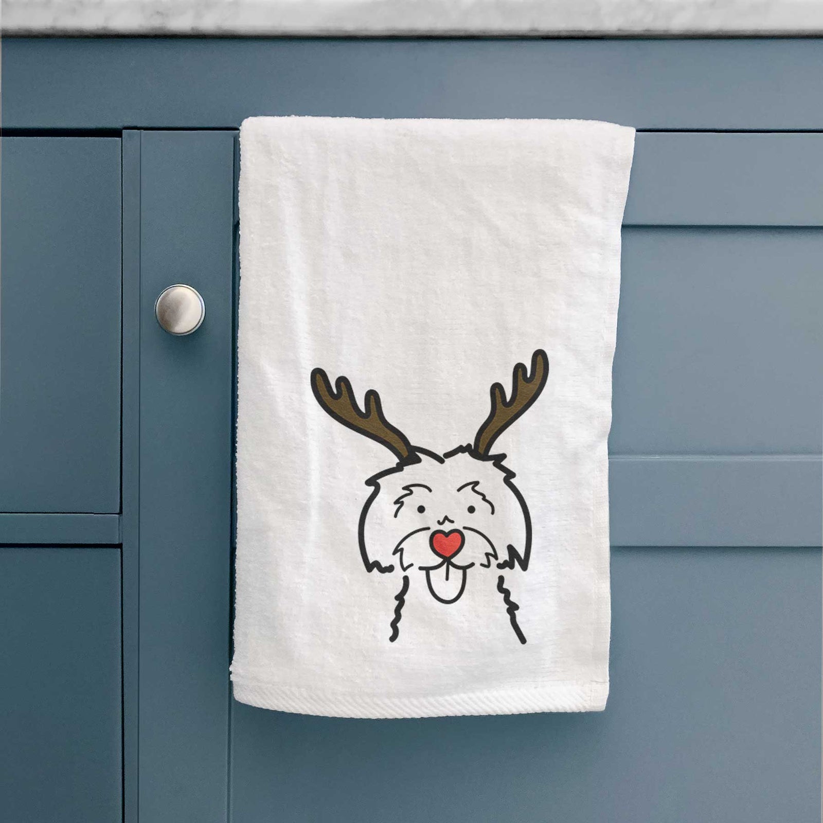 Minimalist line drawing of a Maltese with reindeer antlers and a red nose on a decorative hand towel