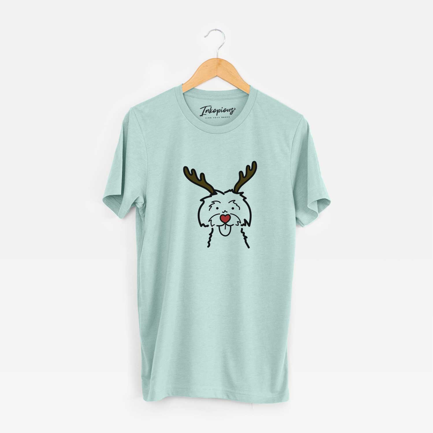 Minimalist line drawing of a Maltese with reindeer antlers and a red nose on a Heather Sage Unisex crewneck