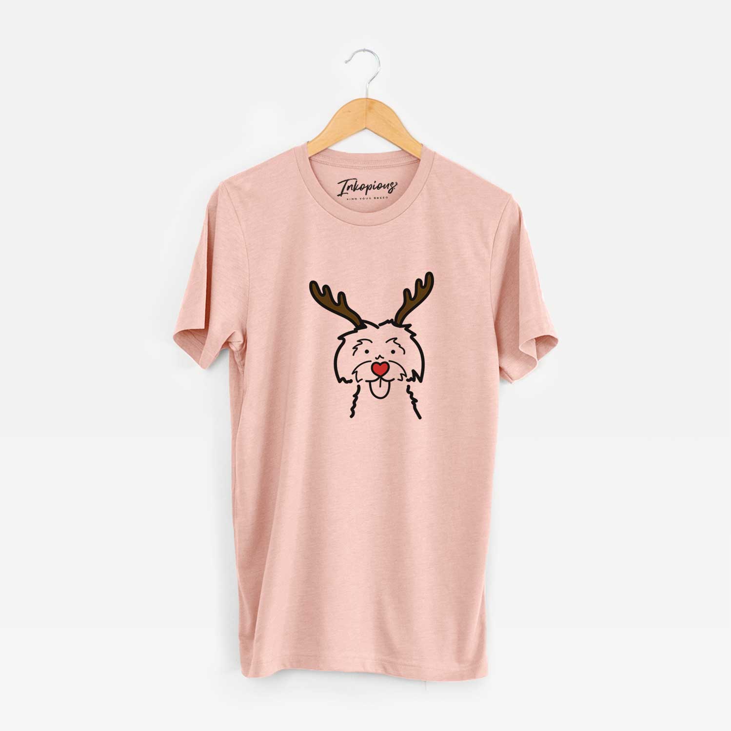 Minimalist line drawing of a Maltese with reindeer antlers and a red nose on a Peach Unisex crewneck
