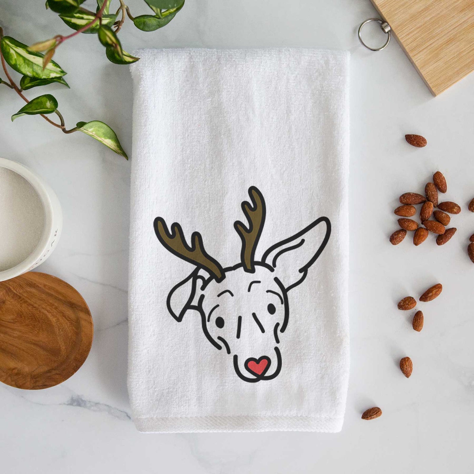 Minimalist line drawing of Millie the Mixed Breed with reindeer antlers and a red nose on a decorative hand towel