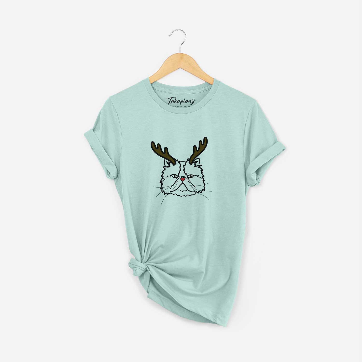 Minimalist line drawing of Mila the Persian Cat with reindeer antlers and a red nose on a Heather Sage Unisex crewneck