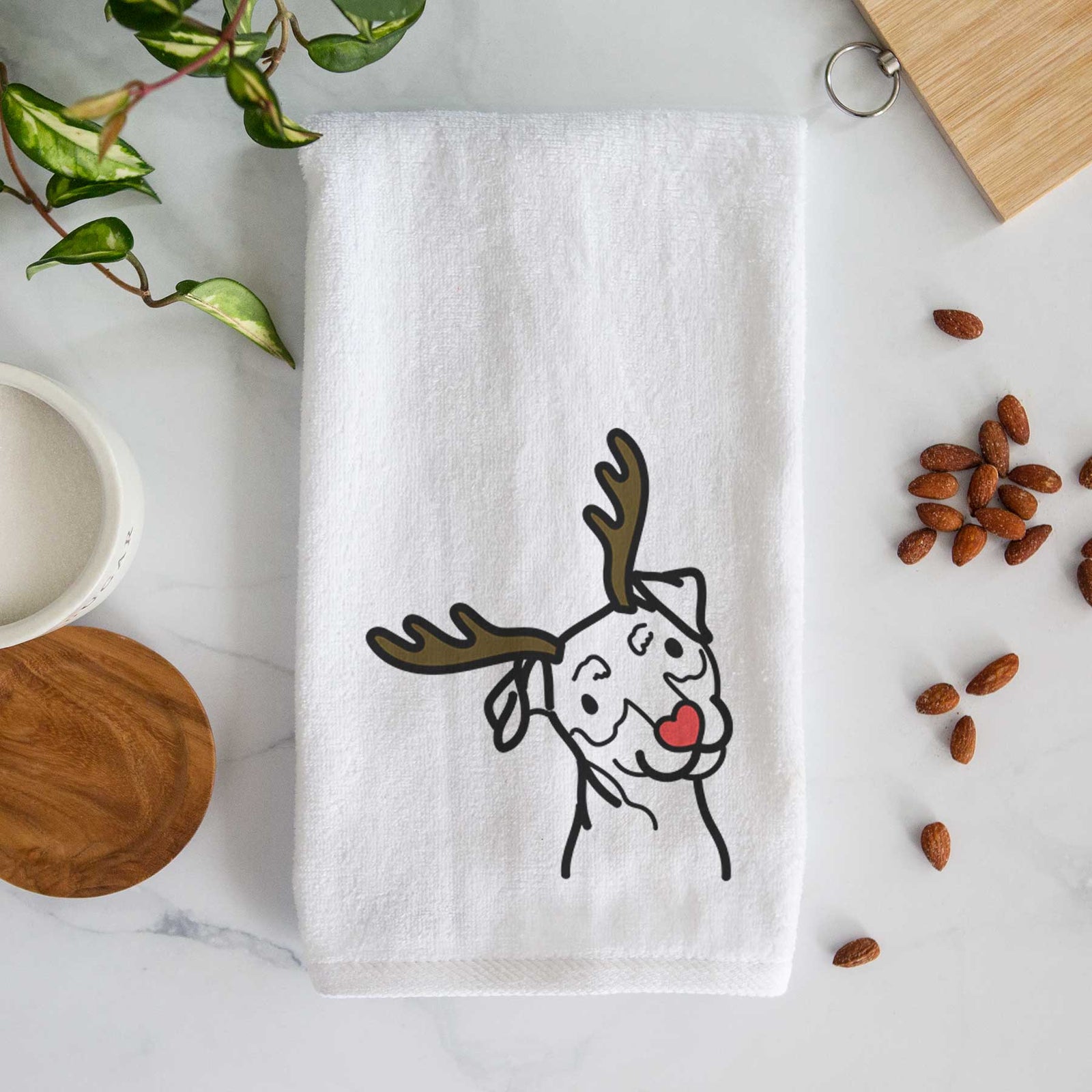 Minimalist line drawing of a Mini Pinscher with reindeer antlers and a red nose on a decorative hand towel