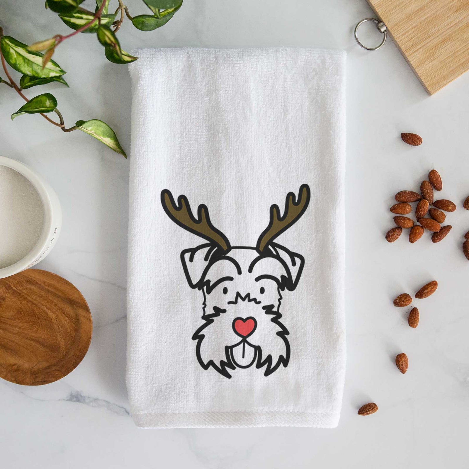 Minimalist line drawing of a Miniature Schnauzer with reindeer antlers and a red nose on a decorative hand towel
