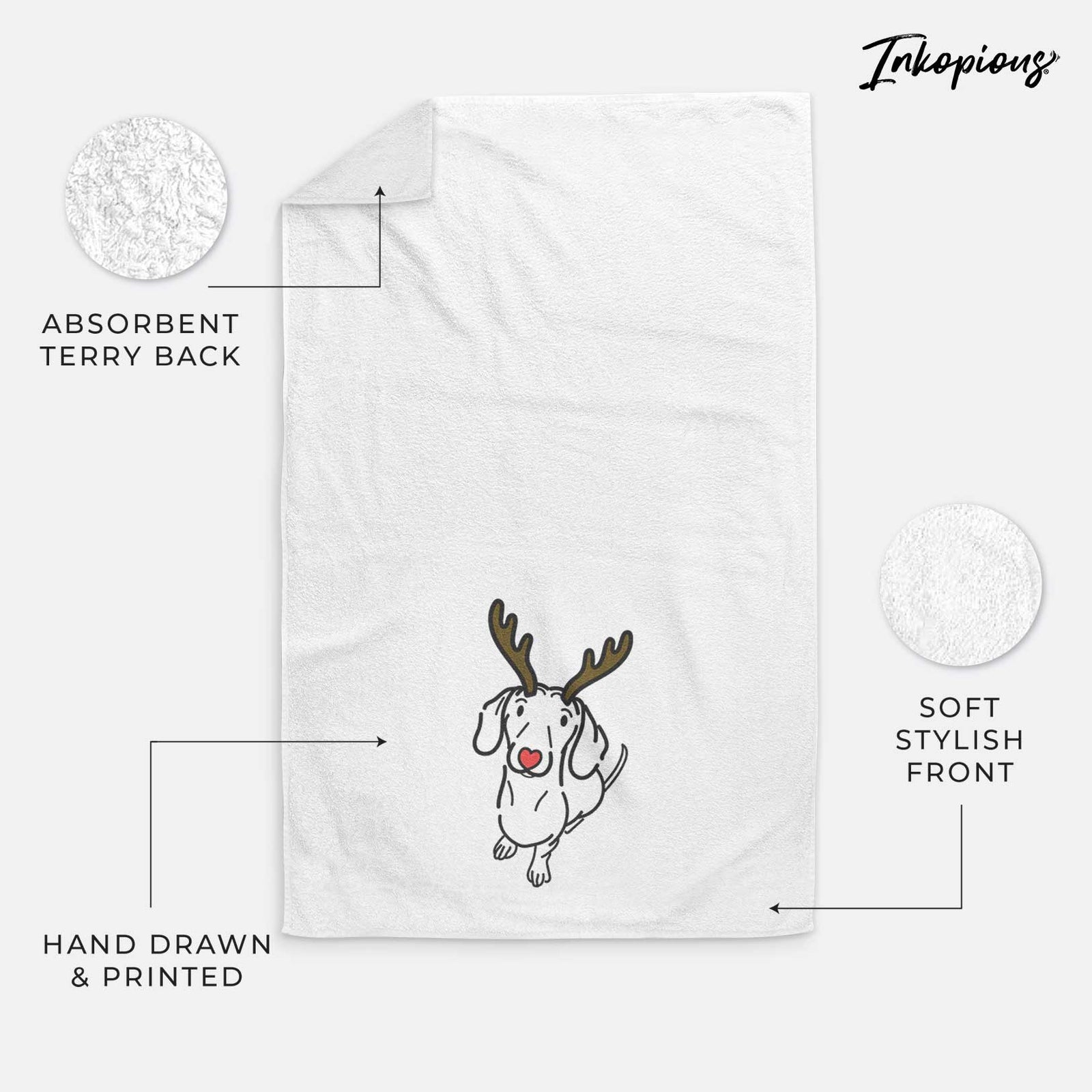 Minimalist line drawing of Moxie the Dachshund with reindeer antlers and a red nose on a decorative hand towel