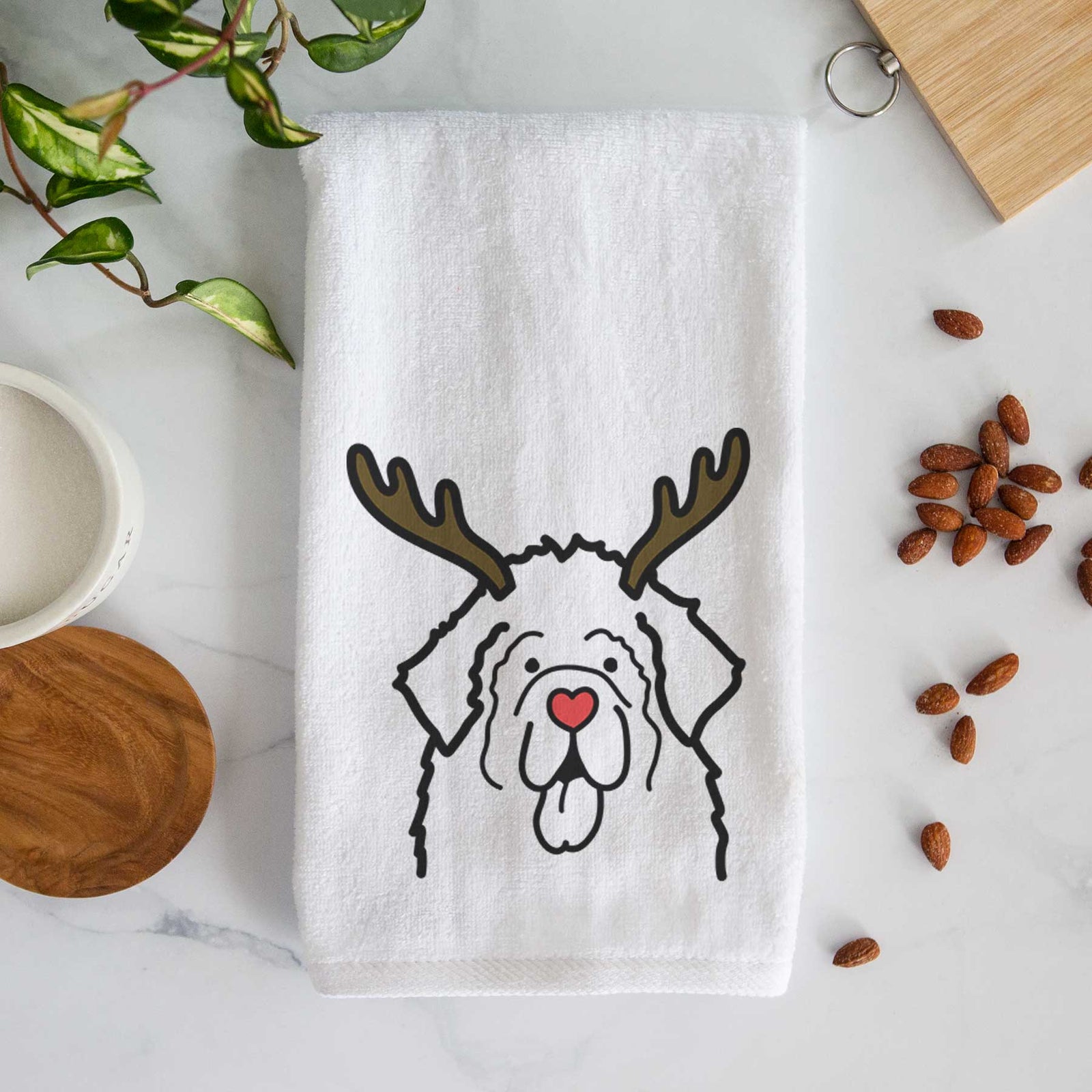 Minimalist line drawing of a Newfoundland with reindeer antlers and a red nose on a decorative hand towel