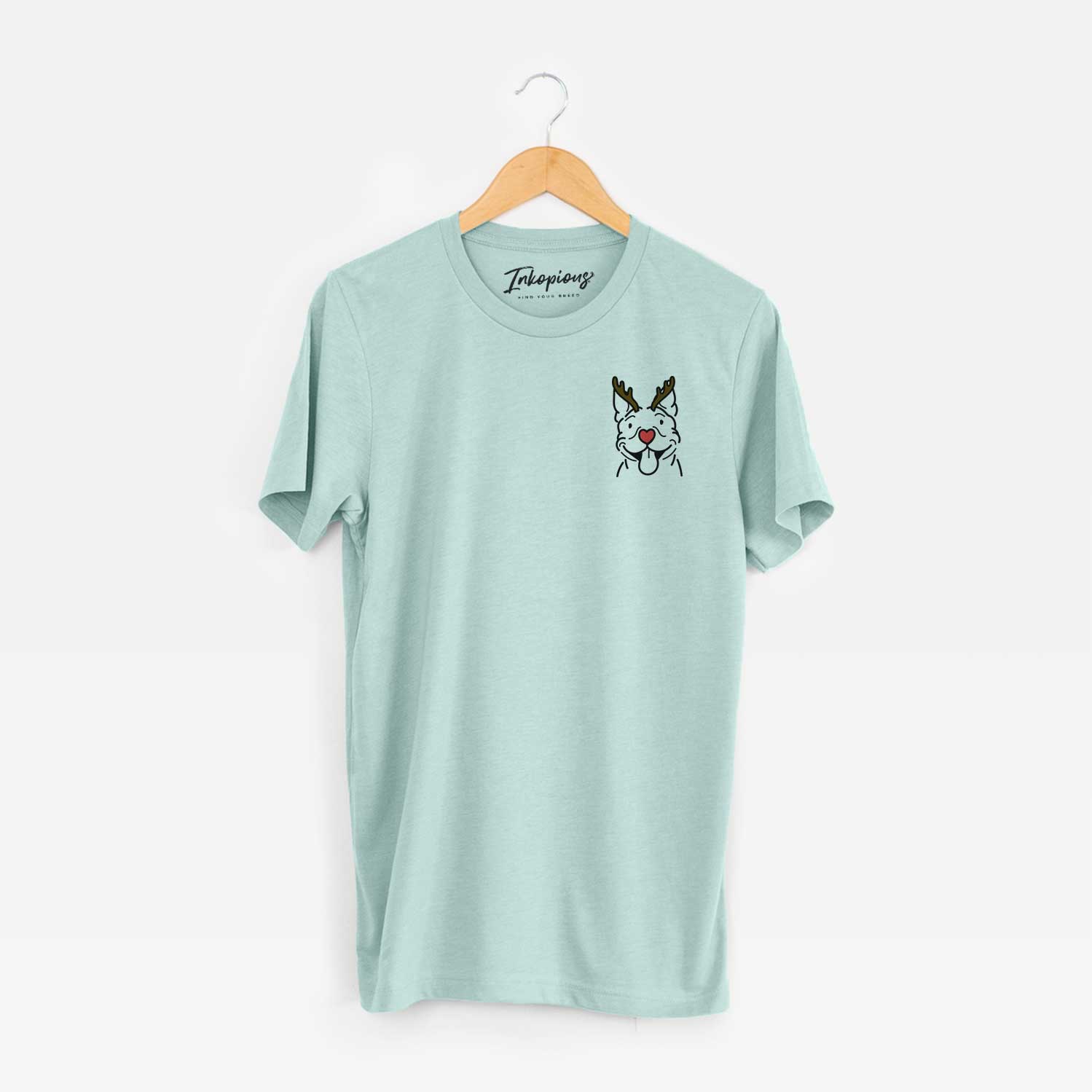 Small chest-pocket minimalist line drawing of Basil the Pitbull with reindeer antlers and a red nose on a Heather Sage Unisex crewneck