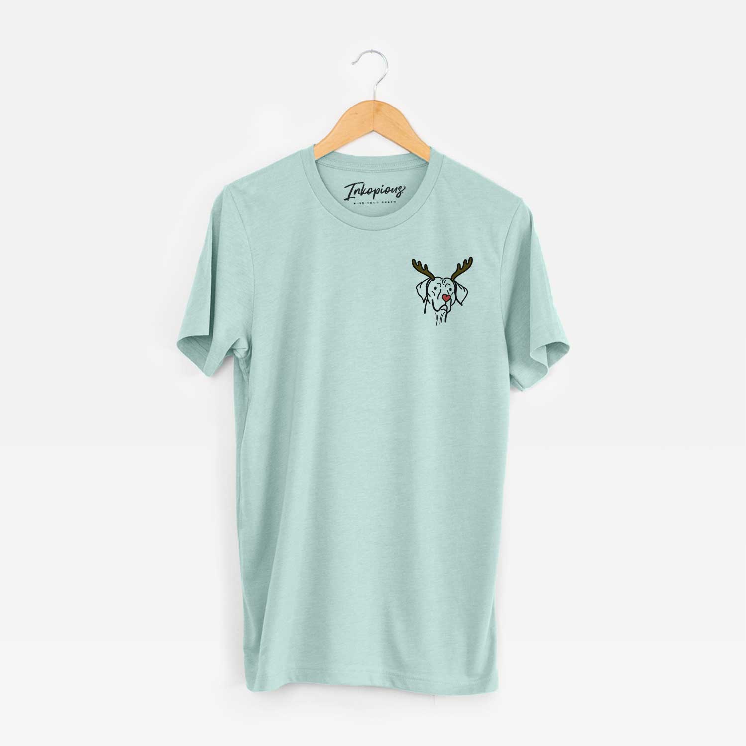 Small chest-pocket minimalist line drawing of Moose the Vizsla with reindeer antlers and a red nose on a Heather Sage Unisex crewneck