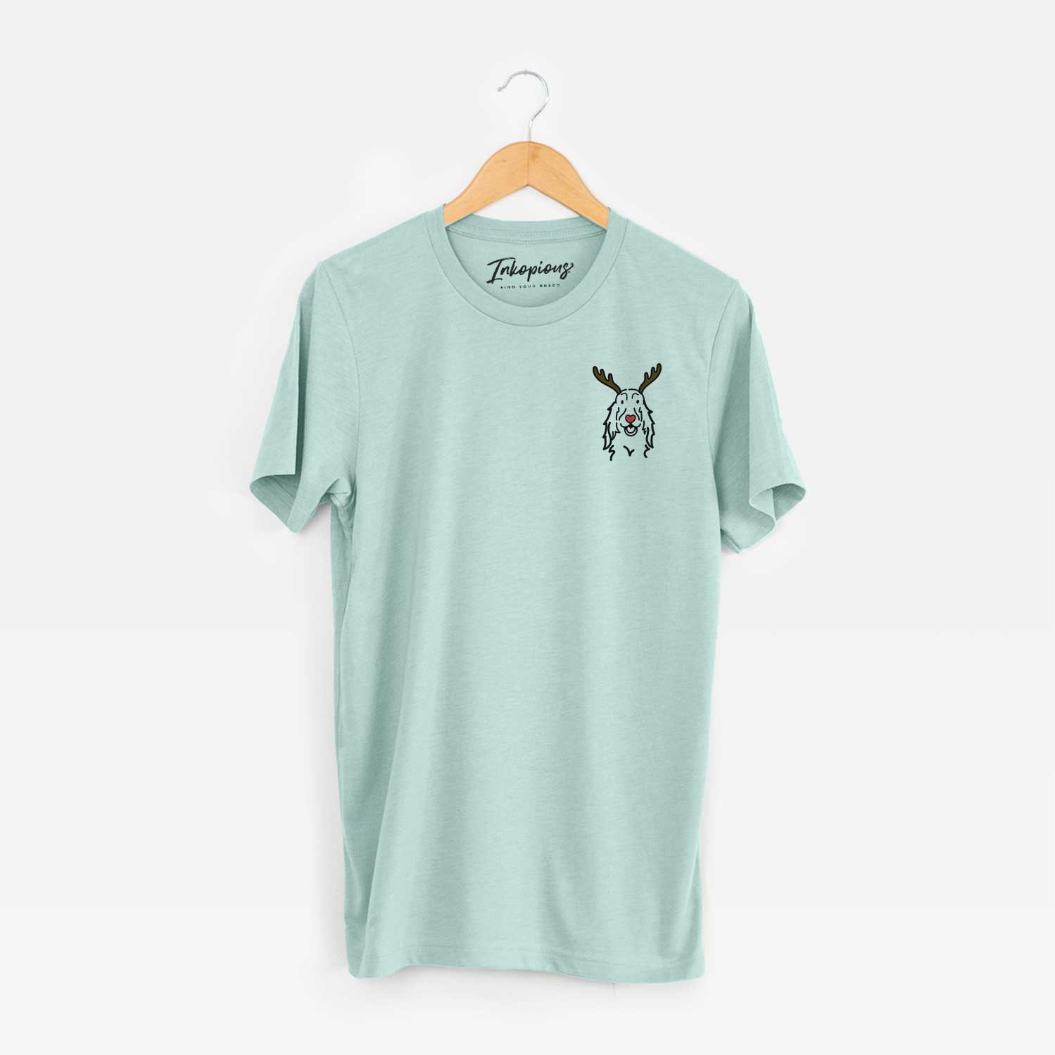 Small chest-pocket minimalist line drawing of a Setter with reindeer antlers and a red nose on a Heather Sage Unisex crewneck