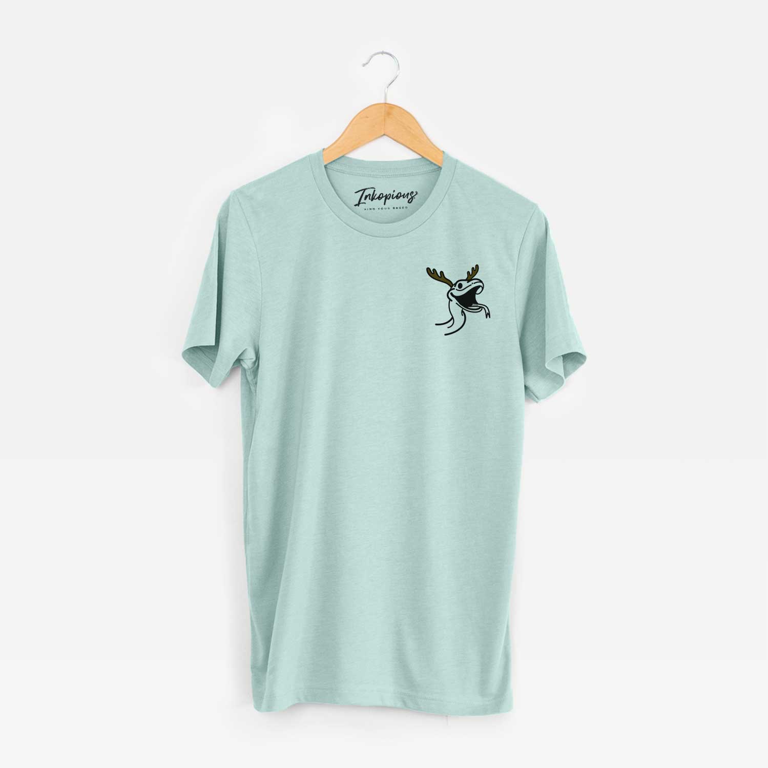 Small chest-pocket minimalist line drawing of Spike the Snake with reindeer antlers and a red nose on a Heather Sage Unisex crewneck