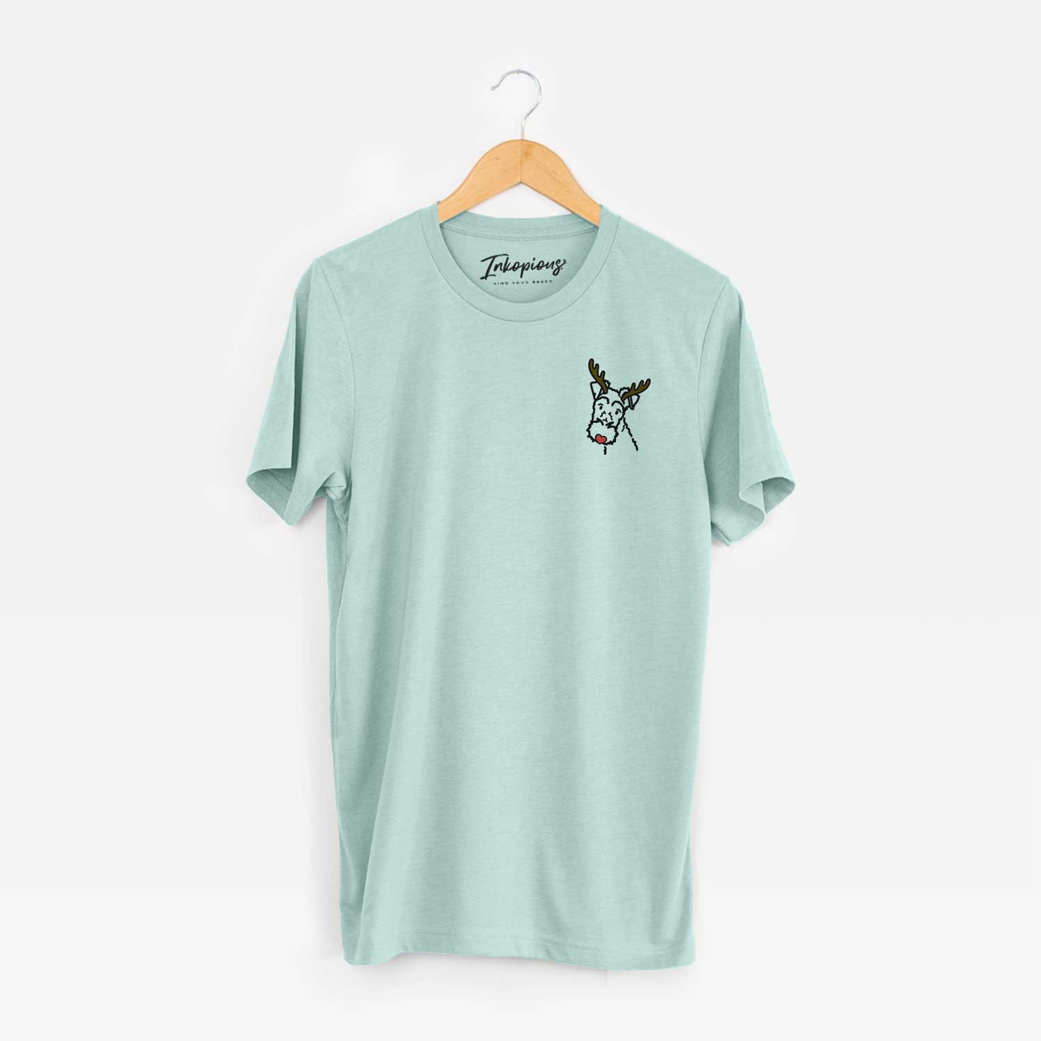 Small chest-pocket minimalist line drawing of a Wire Fox Terrier with reindeer antlers and a red nose on a Heather Sage Unisex crewneck