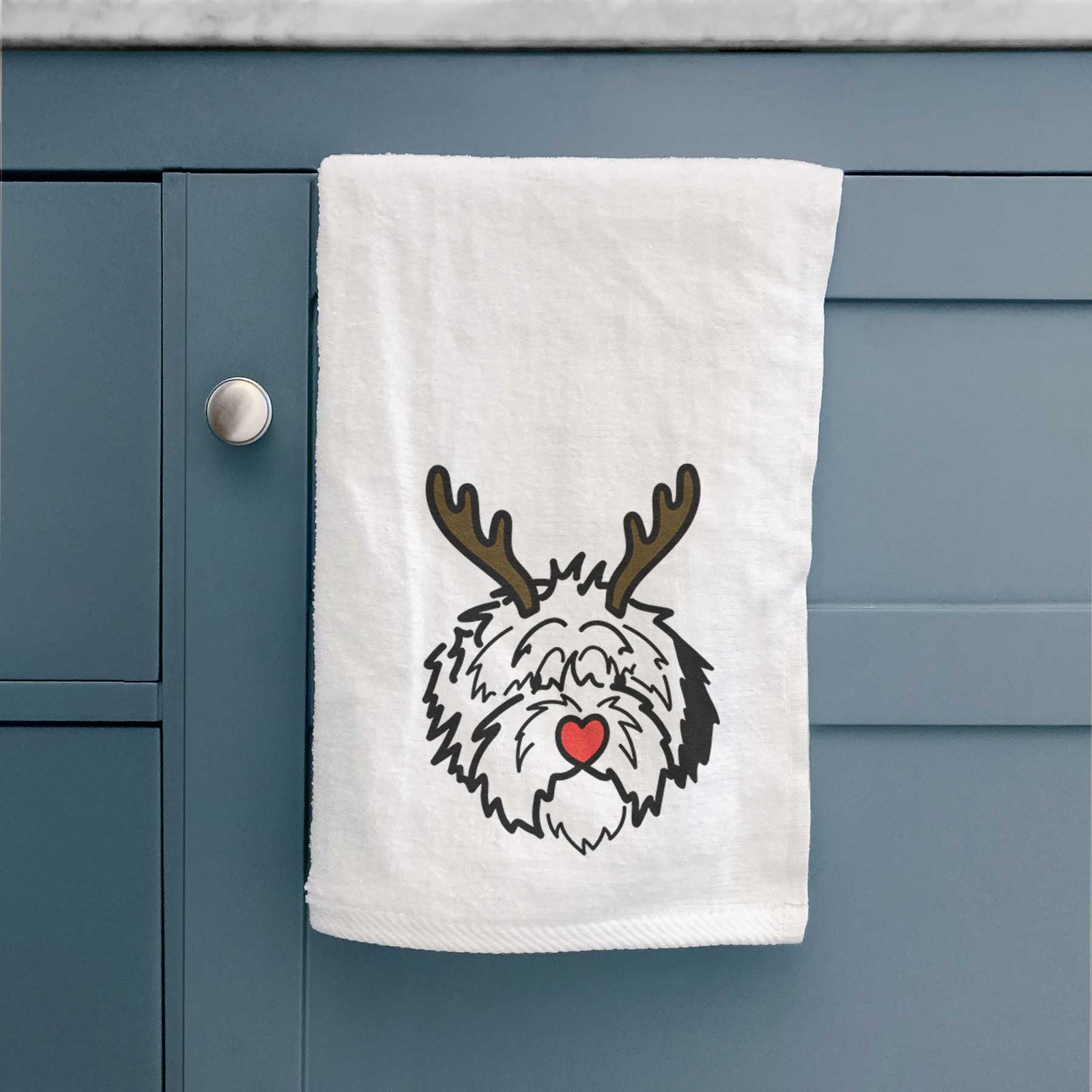Minimalist line drawing of Penny the Old English Sheepdog with reindeer antlers and a red nose on a decorative hand towel