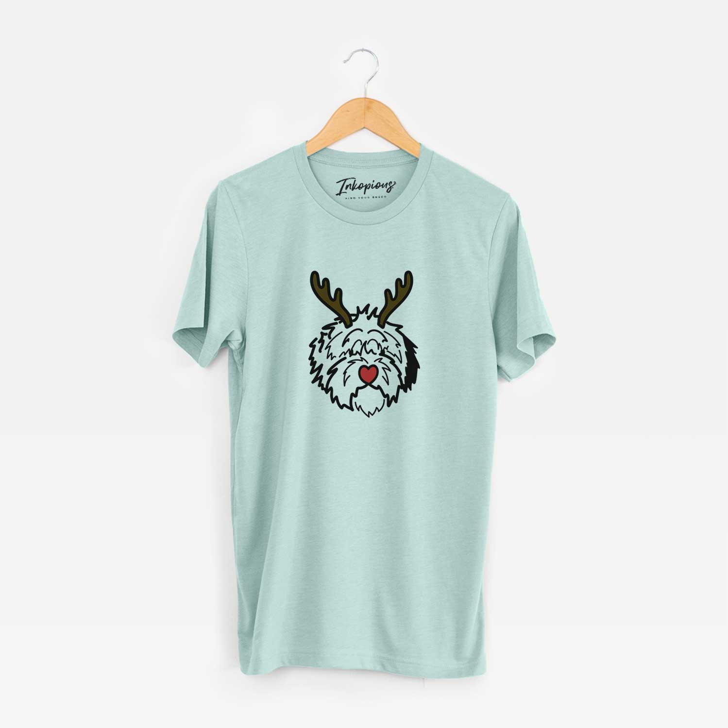 Minimalist line drawing of Penny the Old English Sheepdog with reindeer antlers and a red nose on a Heather Sage Unisex crewneck